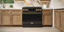 Black gas range with closed oven door and bronze-trim control panel