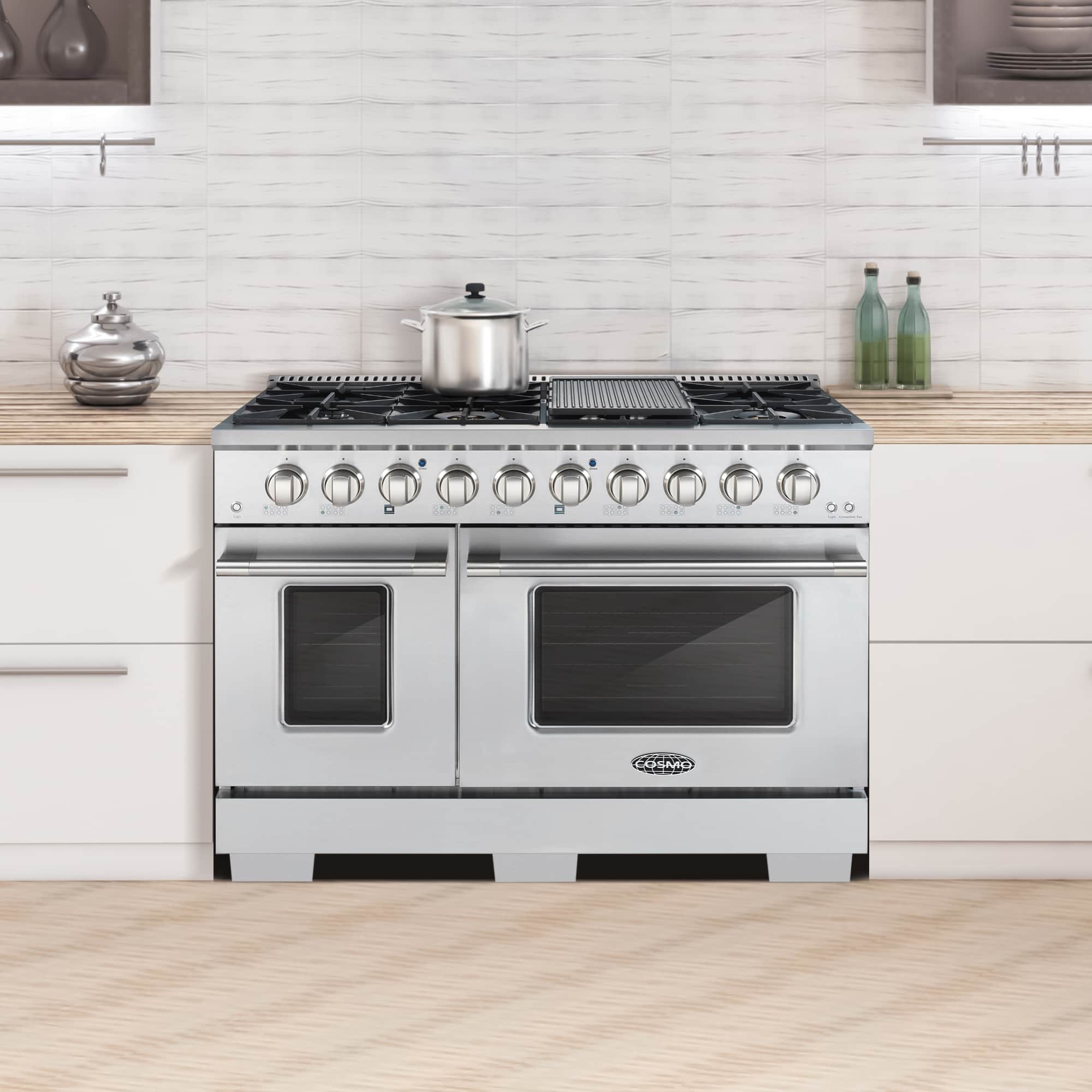 Stainless steel double oven gas range in kitchen setting with two oven doors and front control knobs.