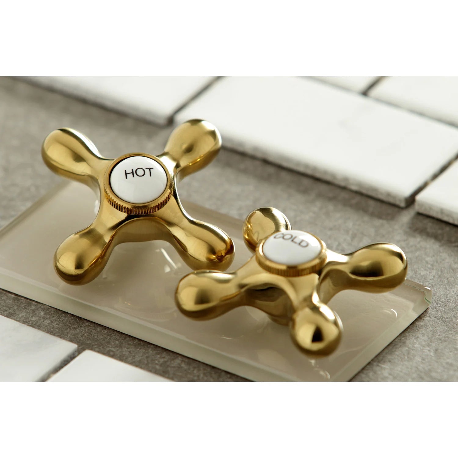 Brushed brass hot and cold cross handles on bridge kitchen faucet