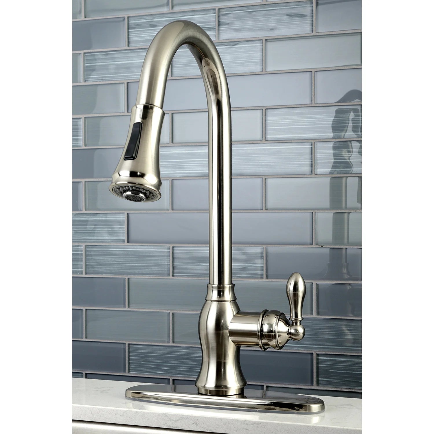 Brushed nickel kitchen faucet with arched spout and pull-down sprayer head