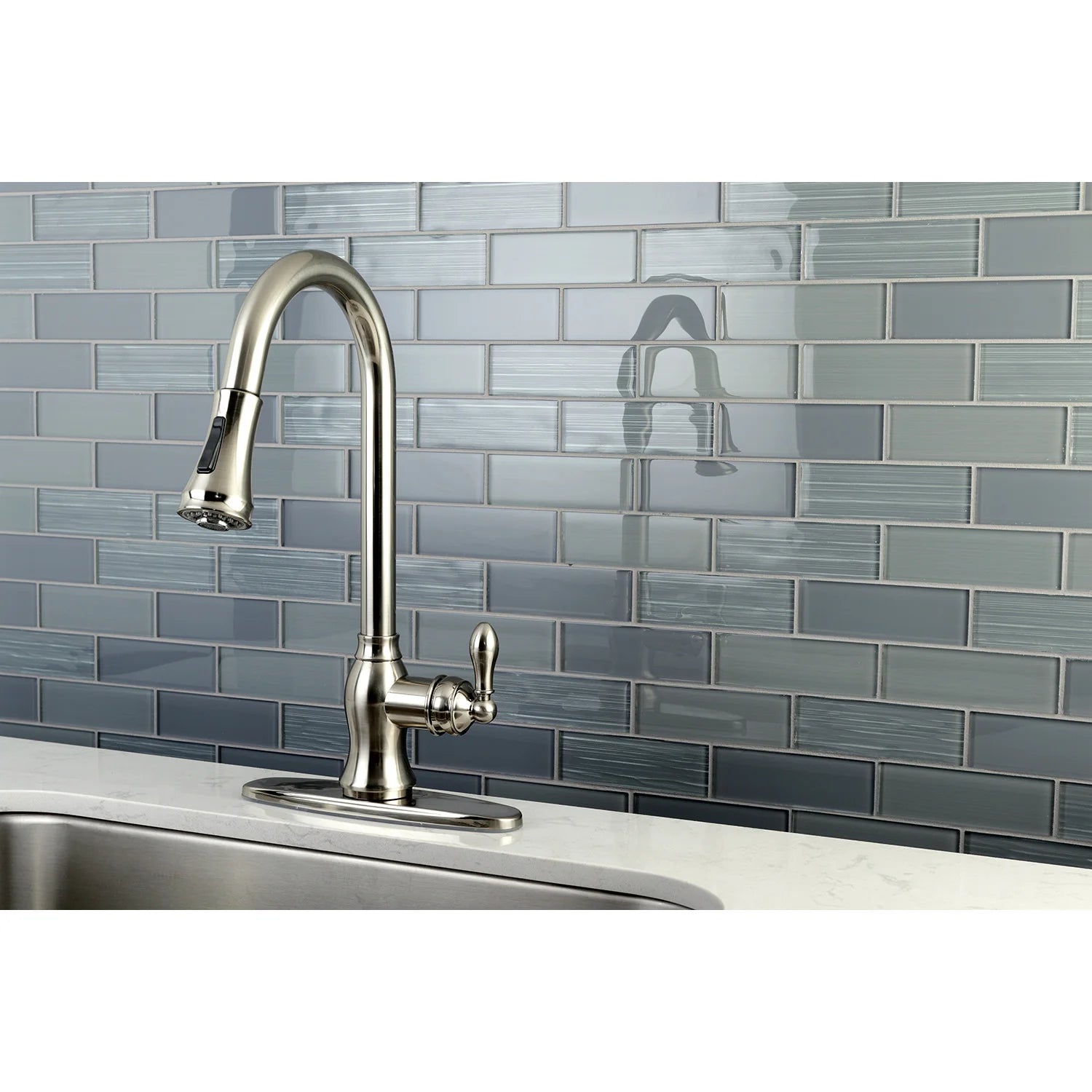 Brushed nickel kitchen faucet with arched spout, handles, and deck plate