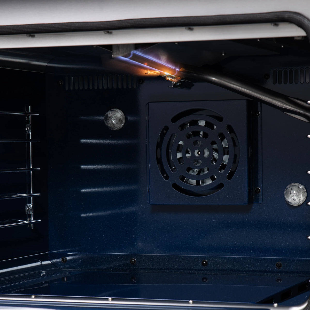 Open convection oven with fan vent and glowing burner flame inside