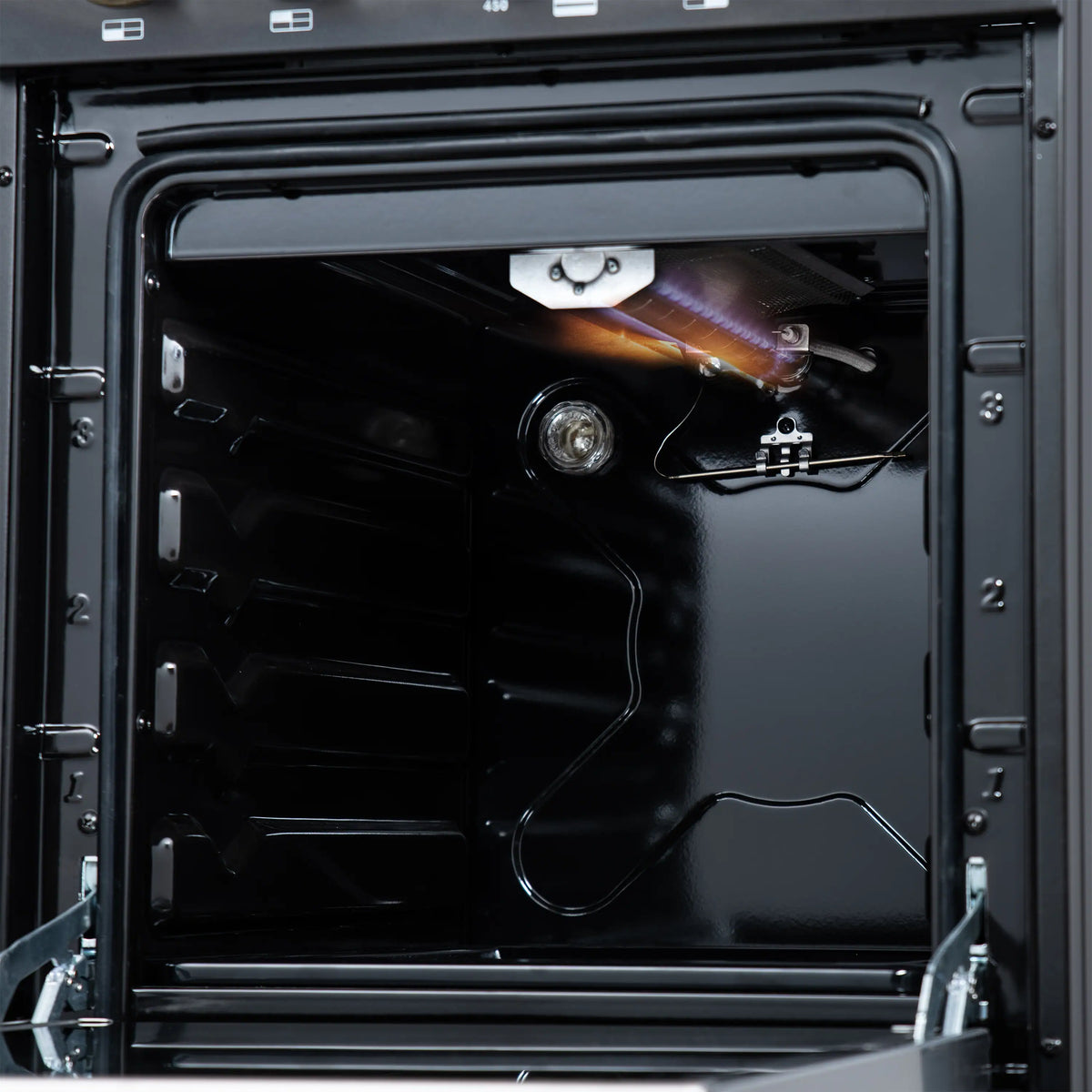 Black gas oven interior with heating element and racks inside