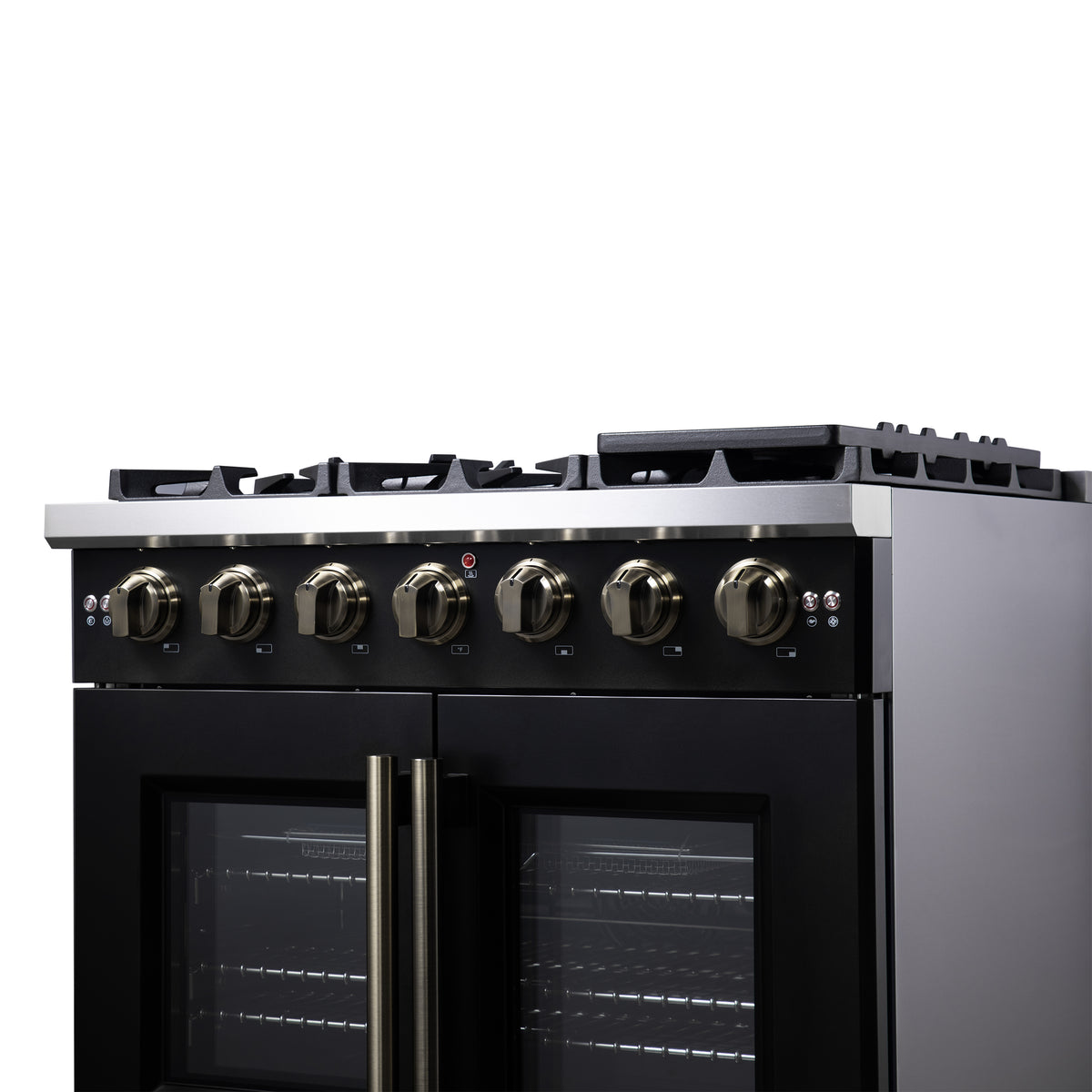 Control panel of black gas range with brass knobs and red indicator light