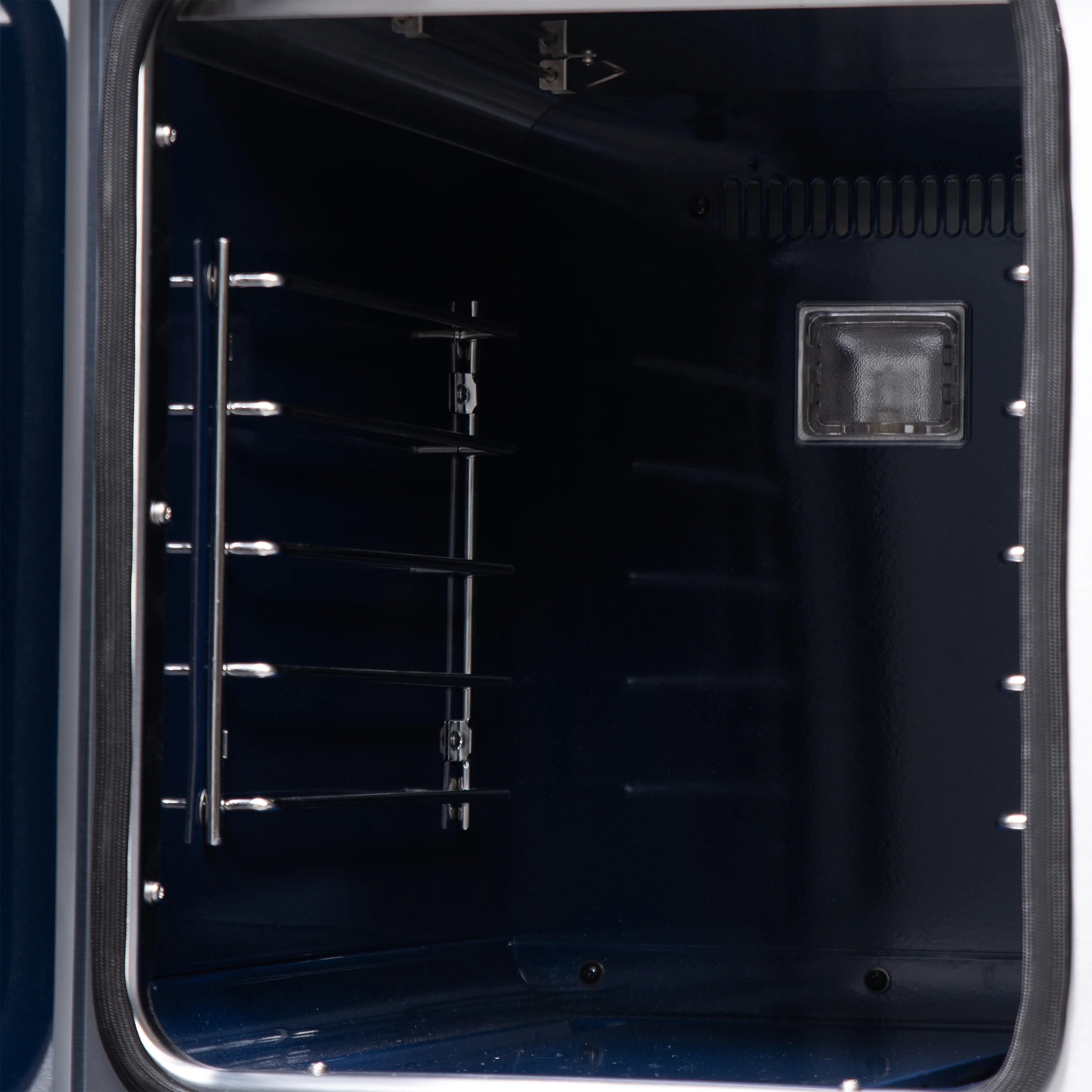 Oven door interior with wire racks and rectangular light cover