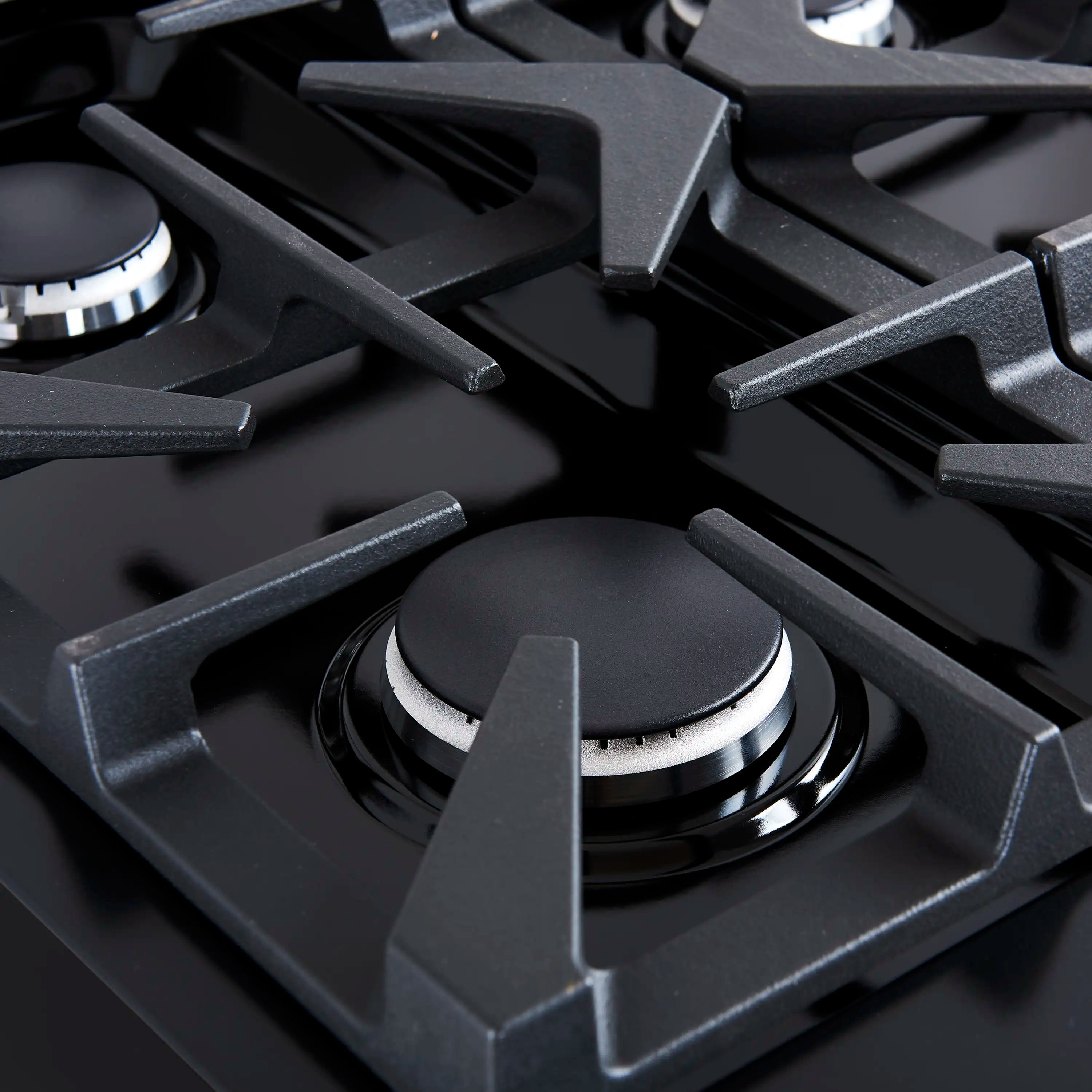 Black dual fuel range burner with cast-iron grate and visible gas igniter rings