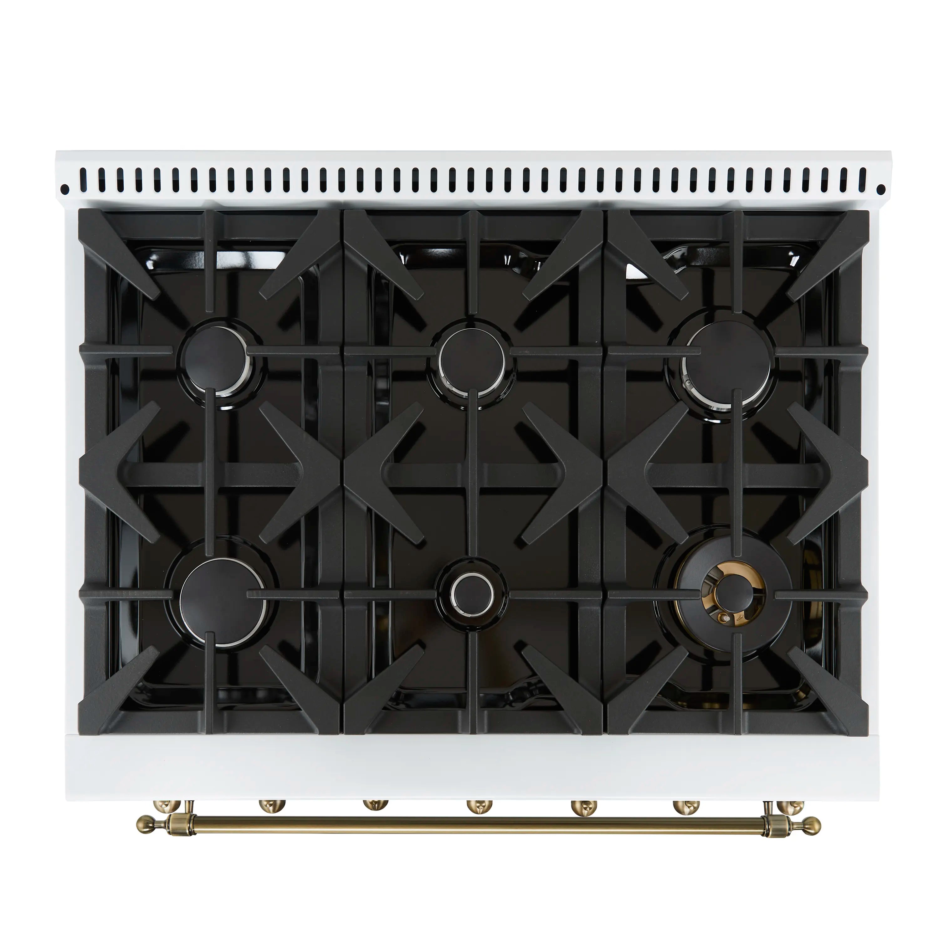 White gas range cooktop with black cast grates and brass front rail