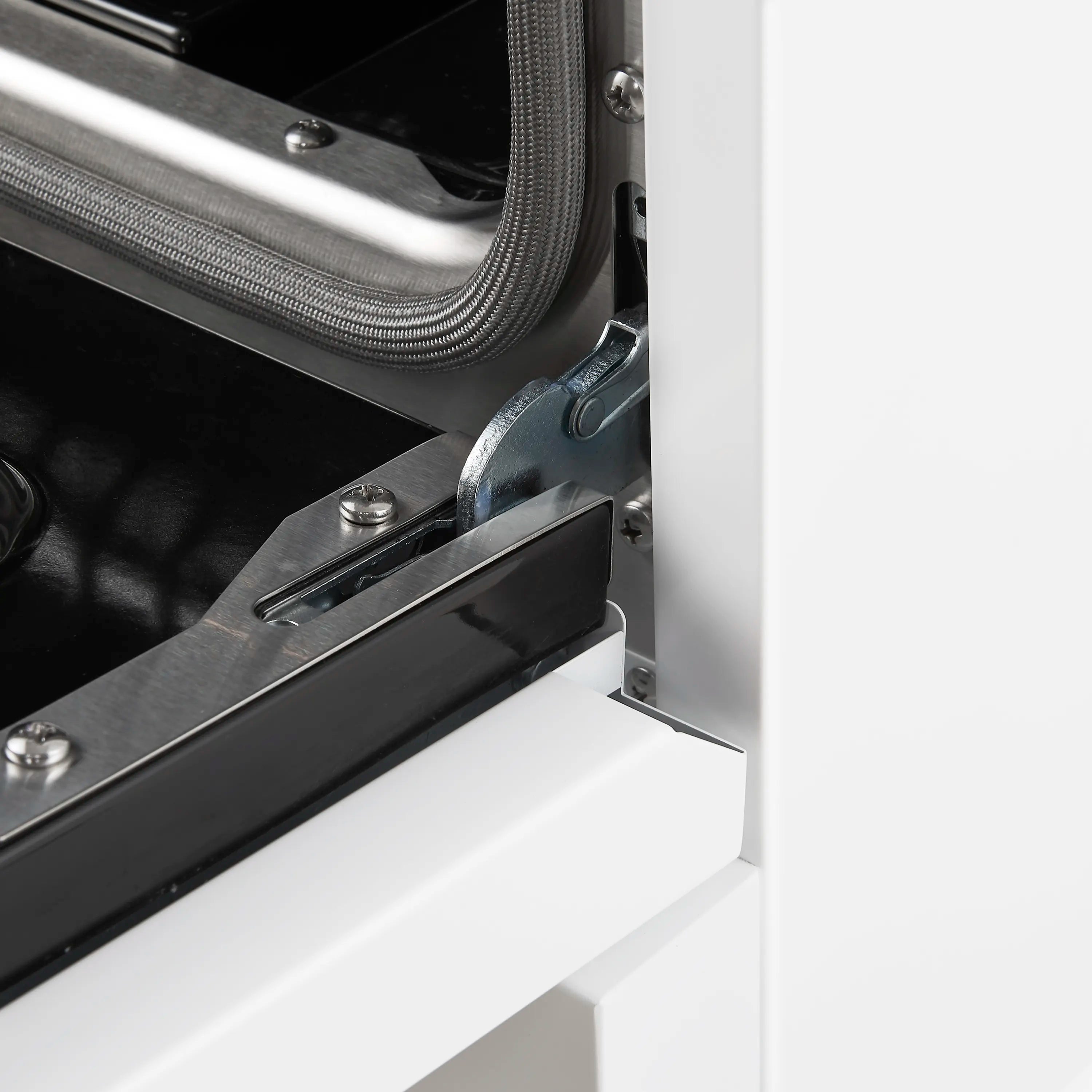 Gas range oven door hinge and interior control area with black handle trim