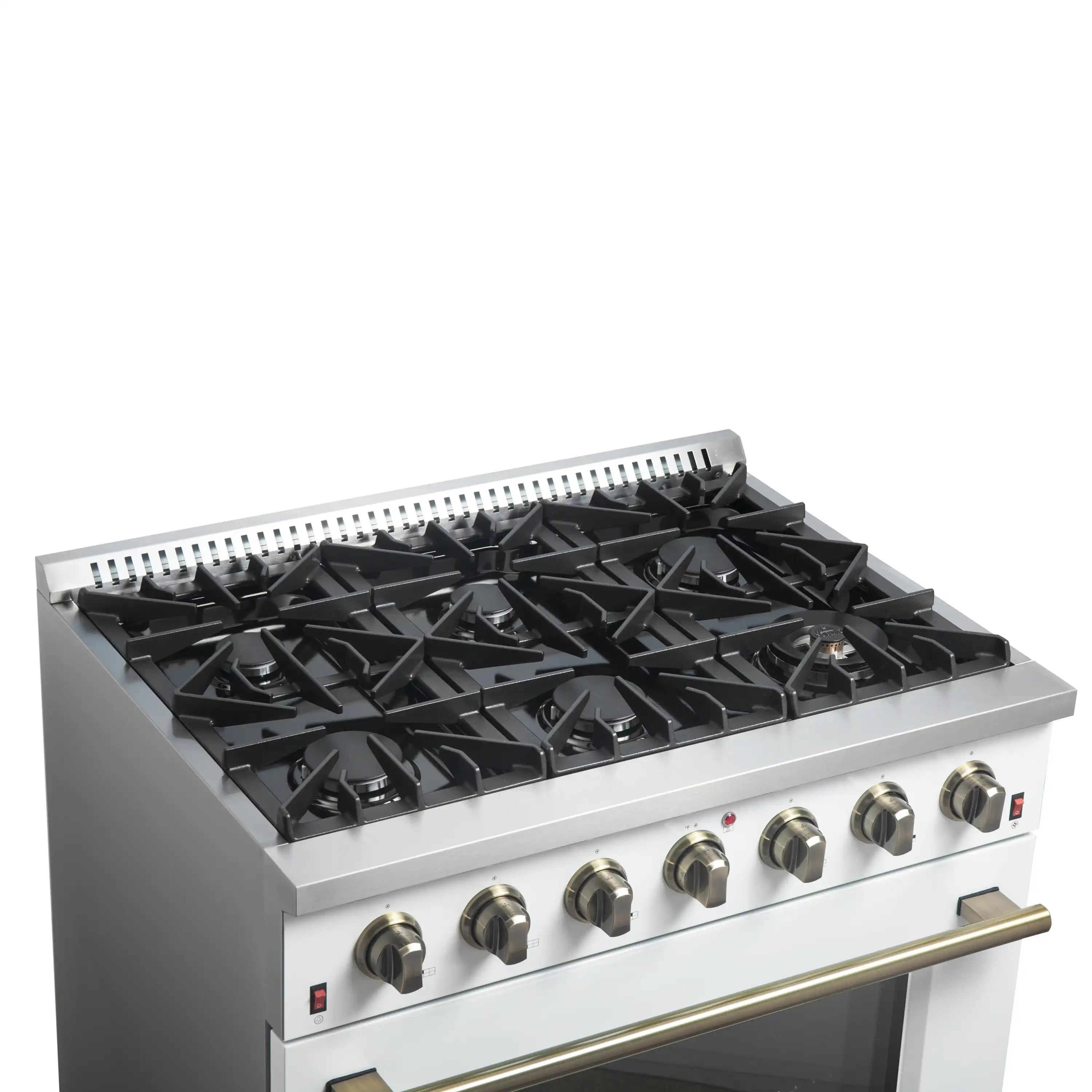 White gas cooktop with black cast-iron grates and brass-trim accents on control panel.
