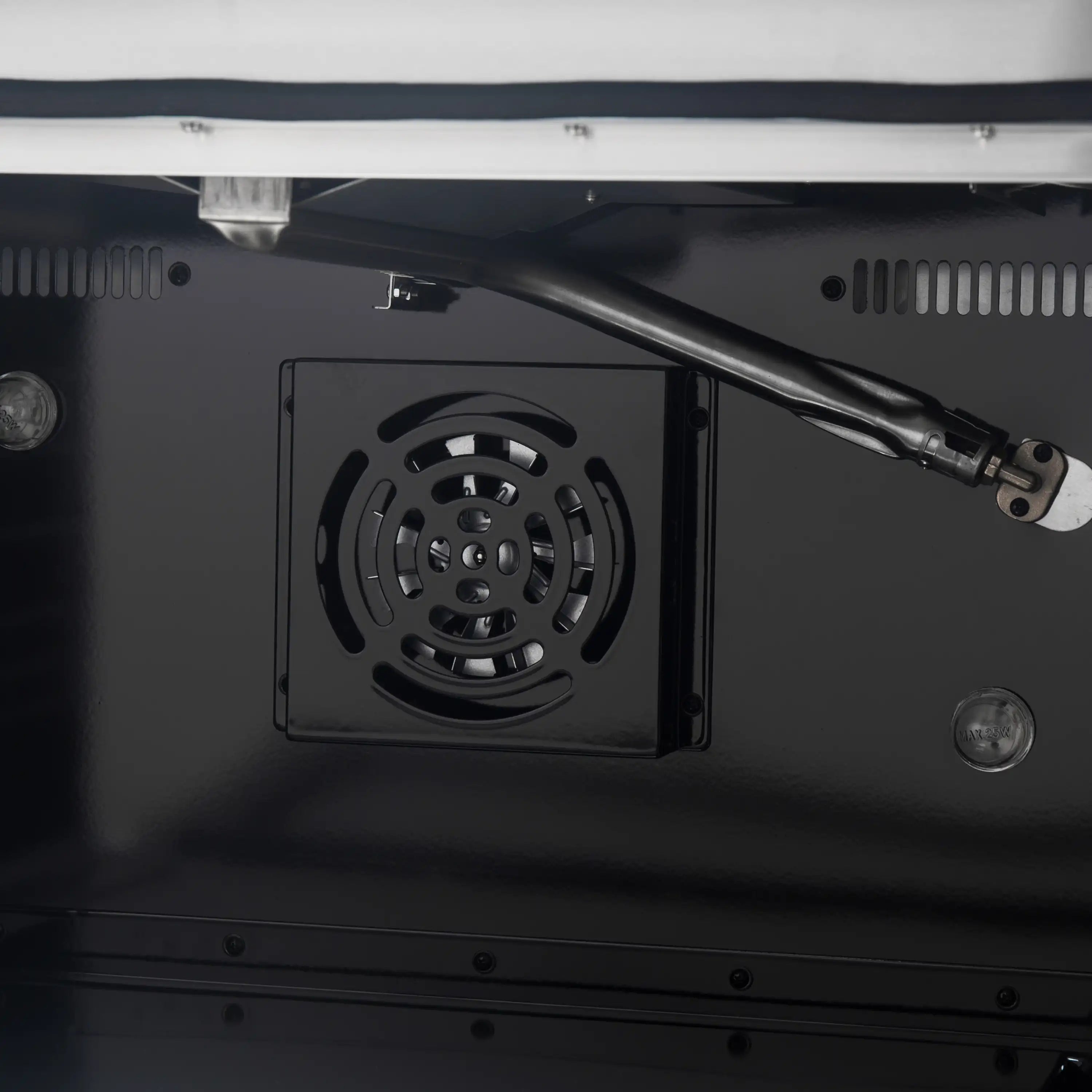 Dark oven cavity with convection fan and oven vent