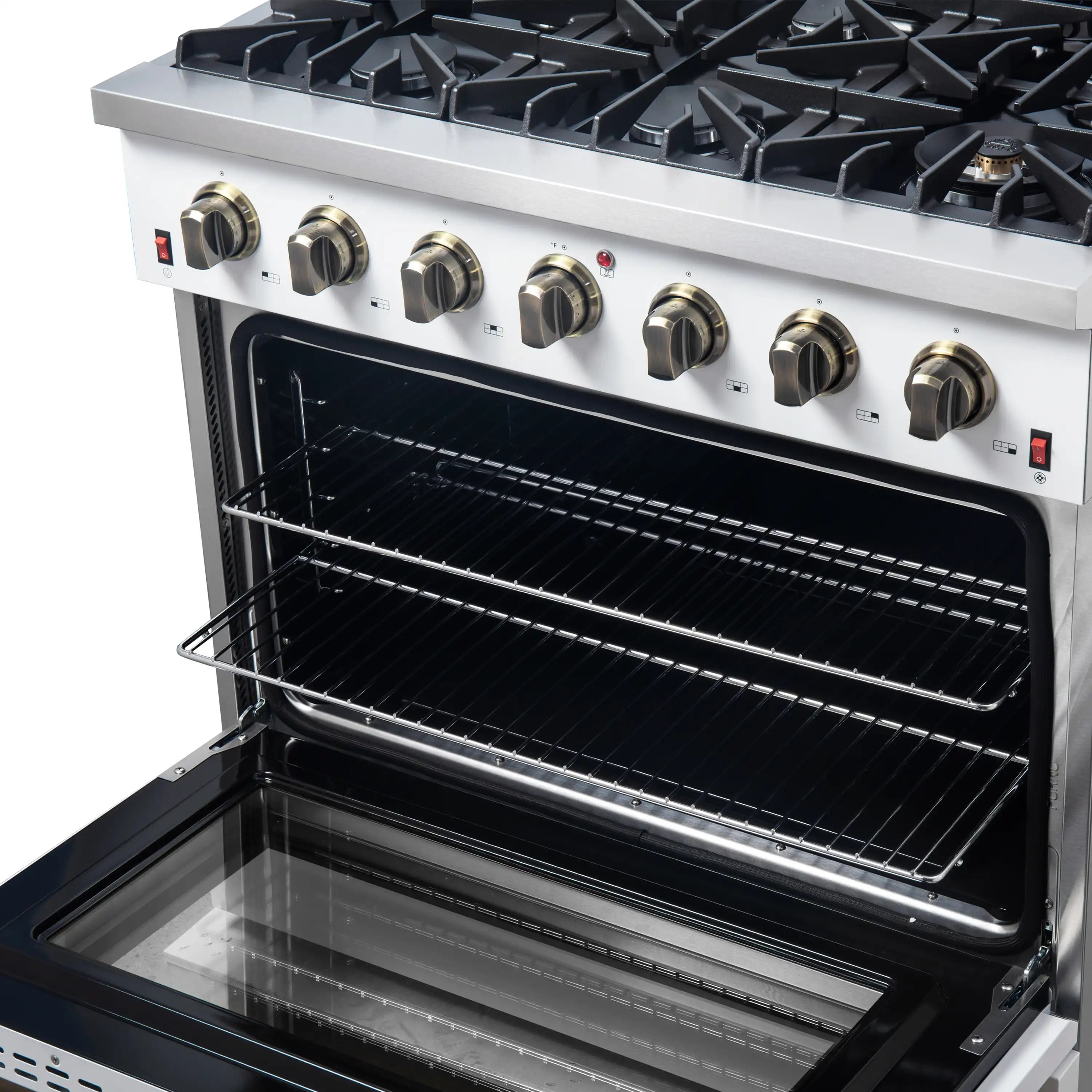 White gas range close-up of control knobs and open oven with black racks