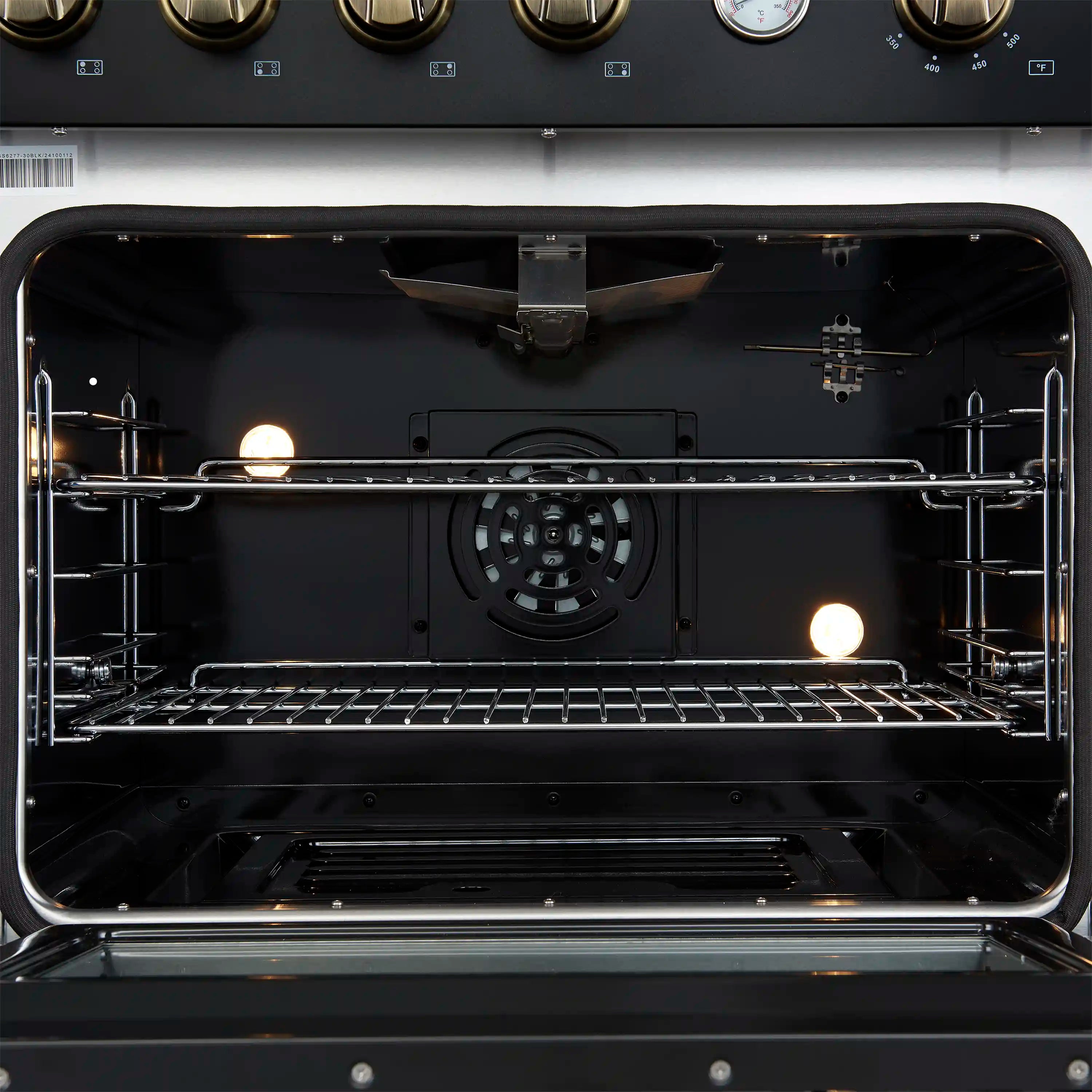 Convection oven interior with dark cavity, racks, and visible fan and heating elements.