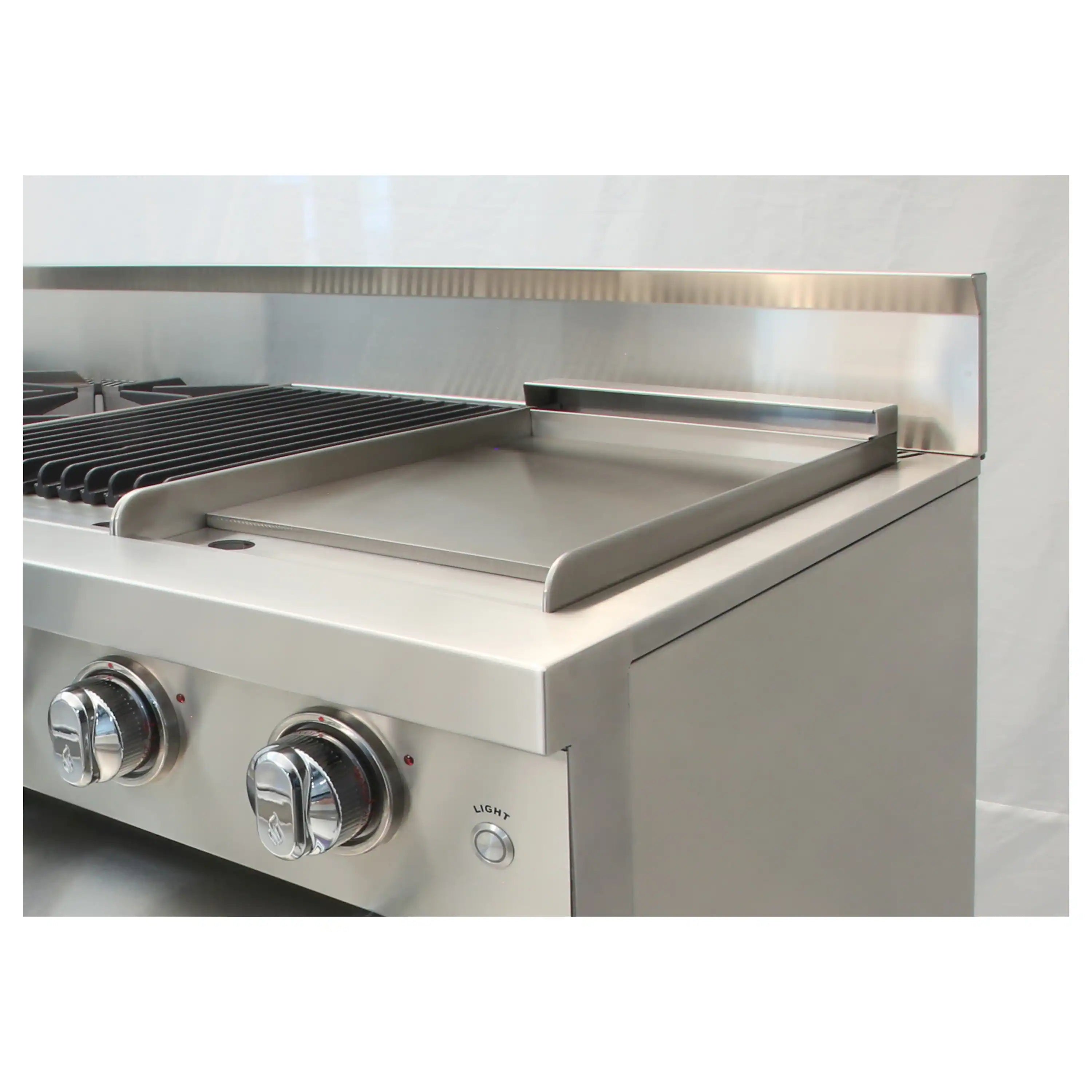 Stainless steel griddle with raised sides and control knobs on gas range