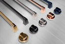 Close-up of burner knobs and trim pieces on a stainless gas range with navy accents.