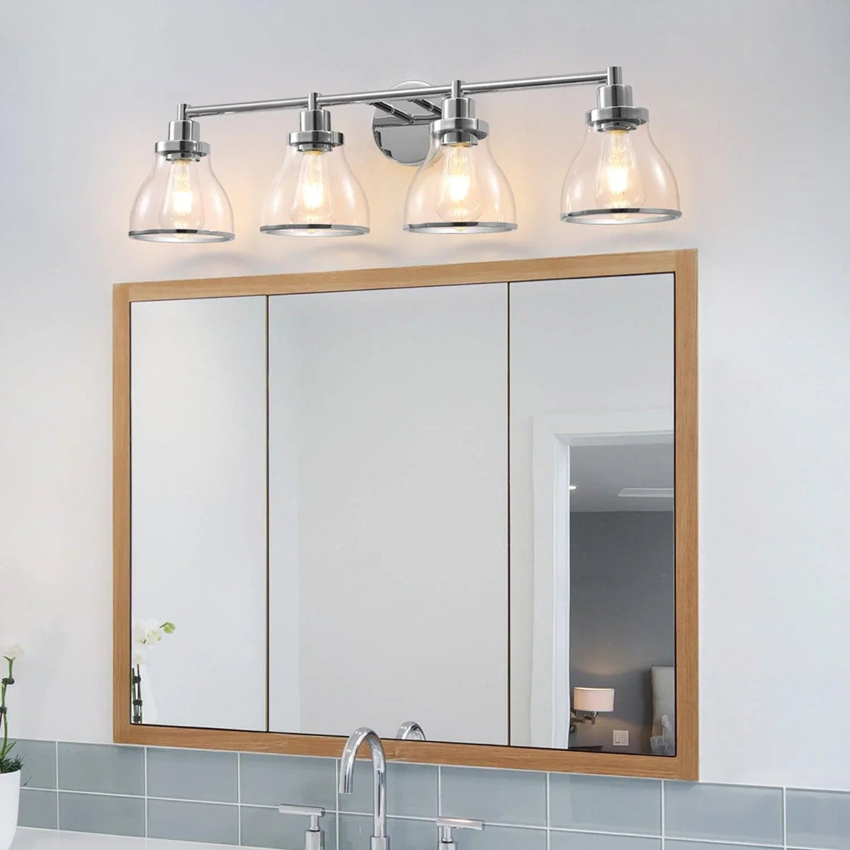 4-light bathroom vanity light with chrome bar and clear glass shades over mirrors