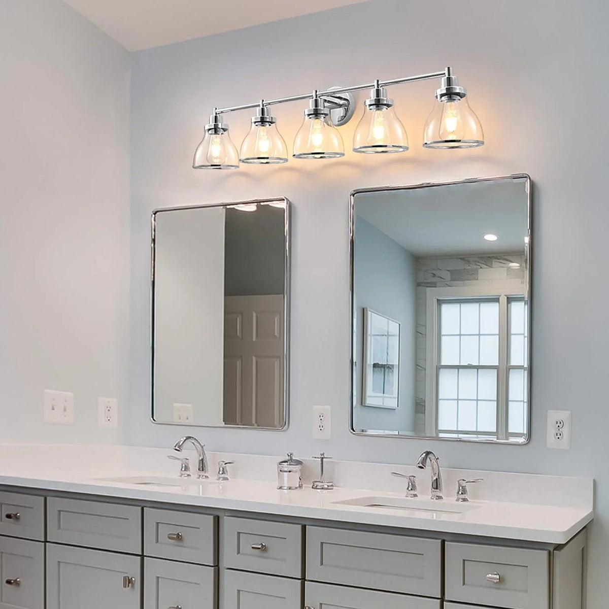 5-light polished nickel vanity light with clear glass shades mounted above mirrors