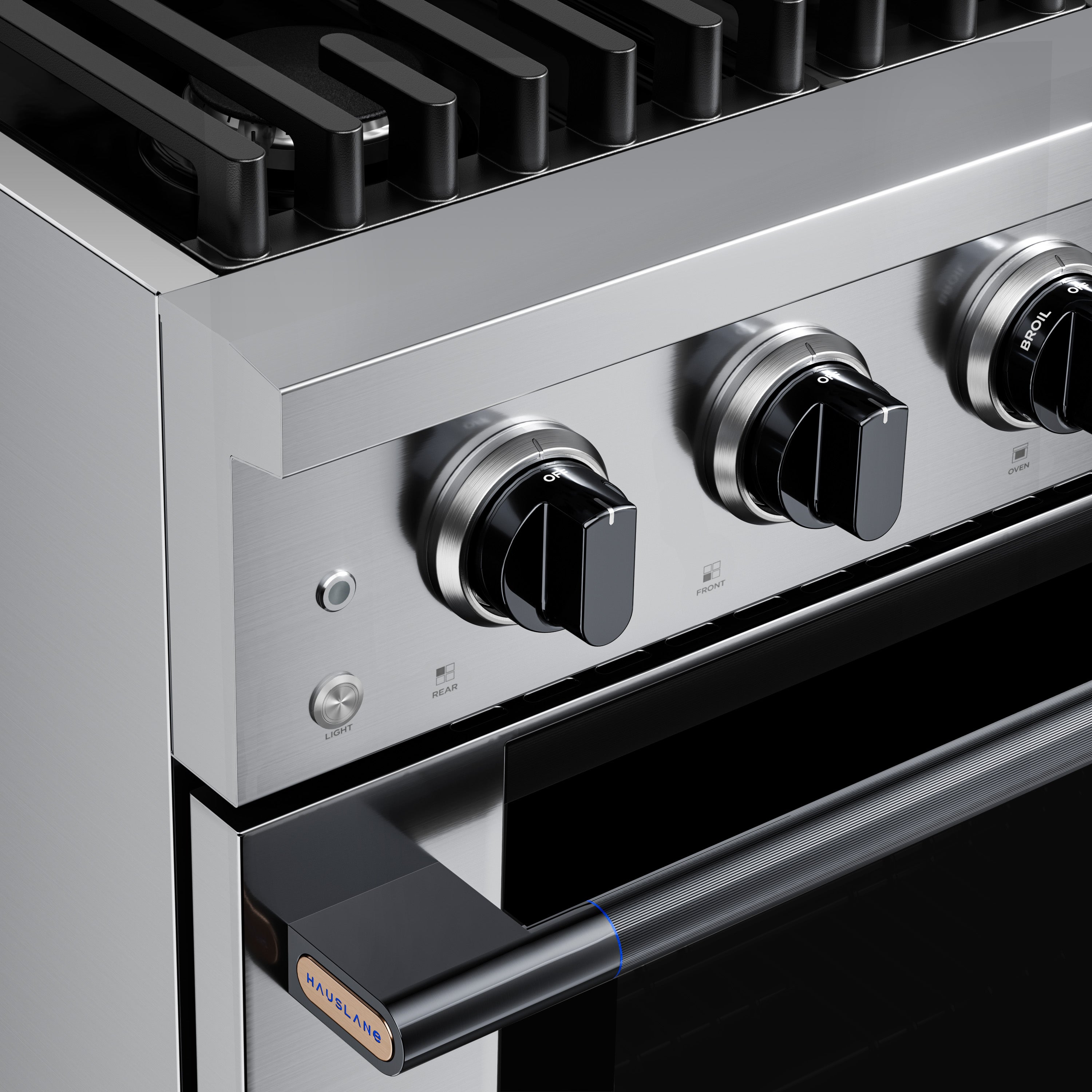 Stainless steel gas range cooktop with four silver knobs and black handle area