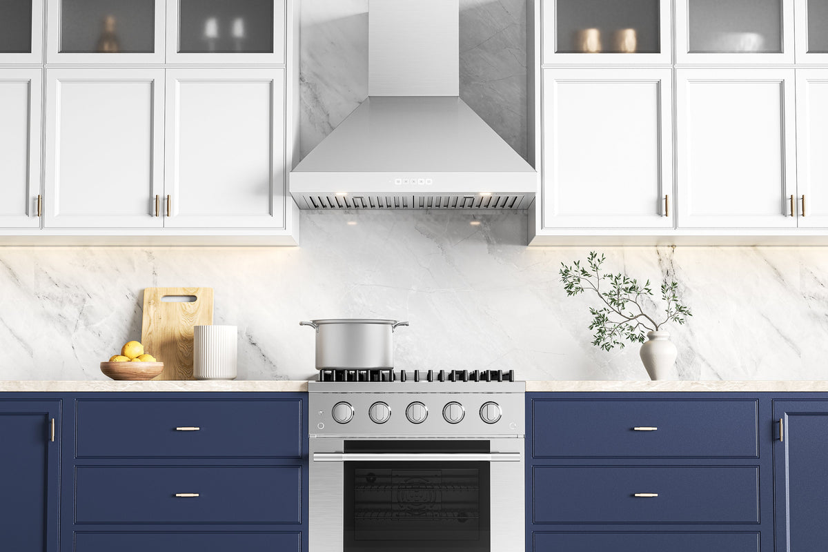 Stainless steel convertible wall mount range hood installed above a cooktop in a kitchen.
