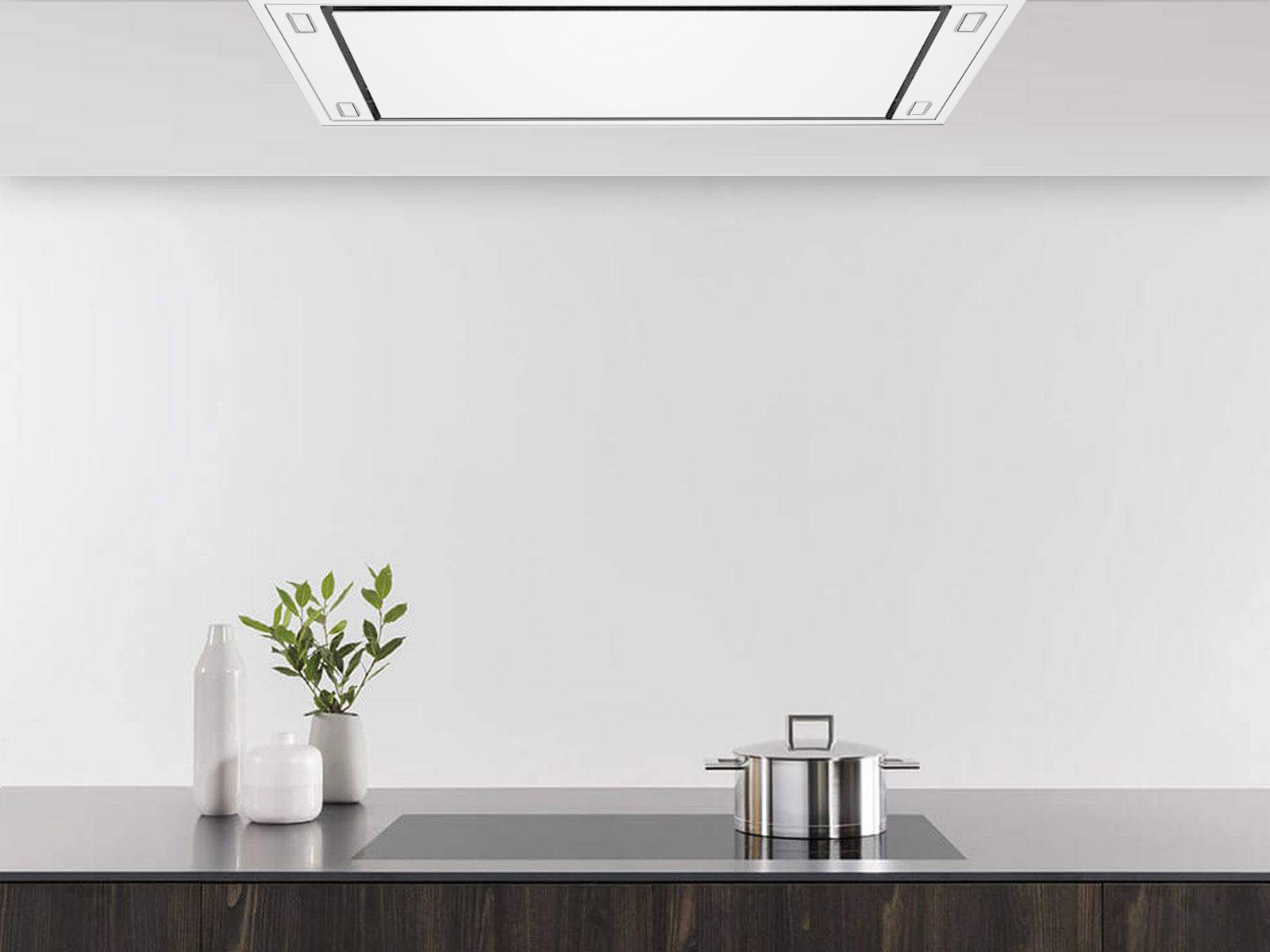 White flush ceiling range hood centered above a stovetop with exhaust opening