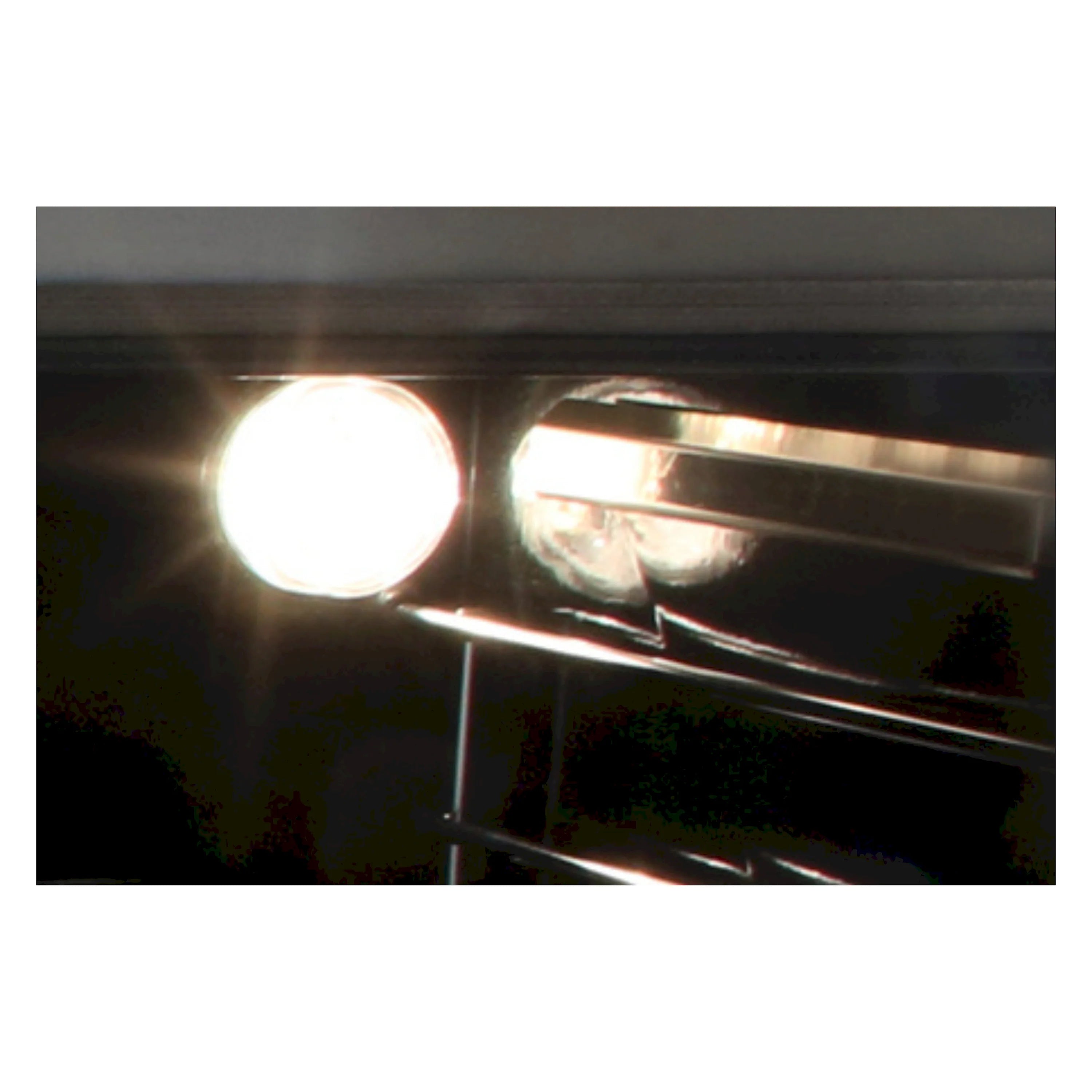 Gas oven burner igniter glowing near heating element inside stainless oven