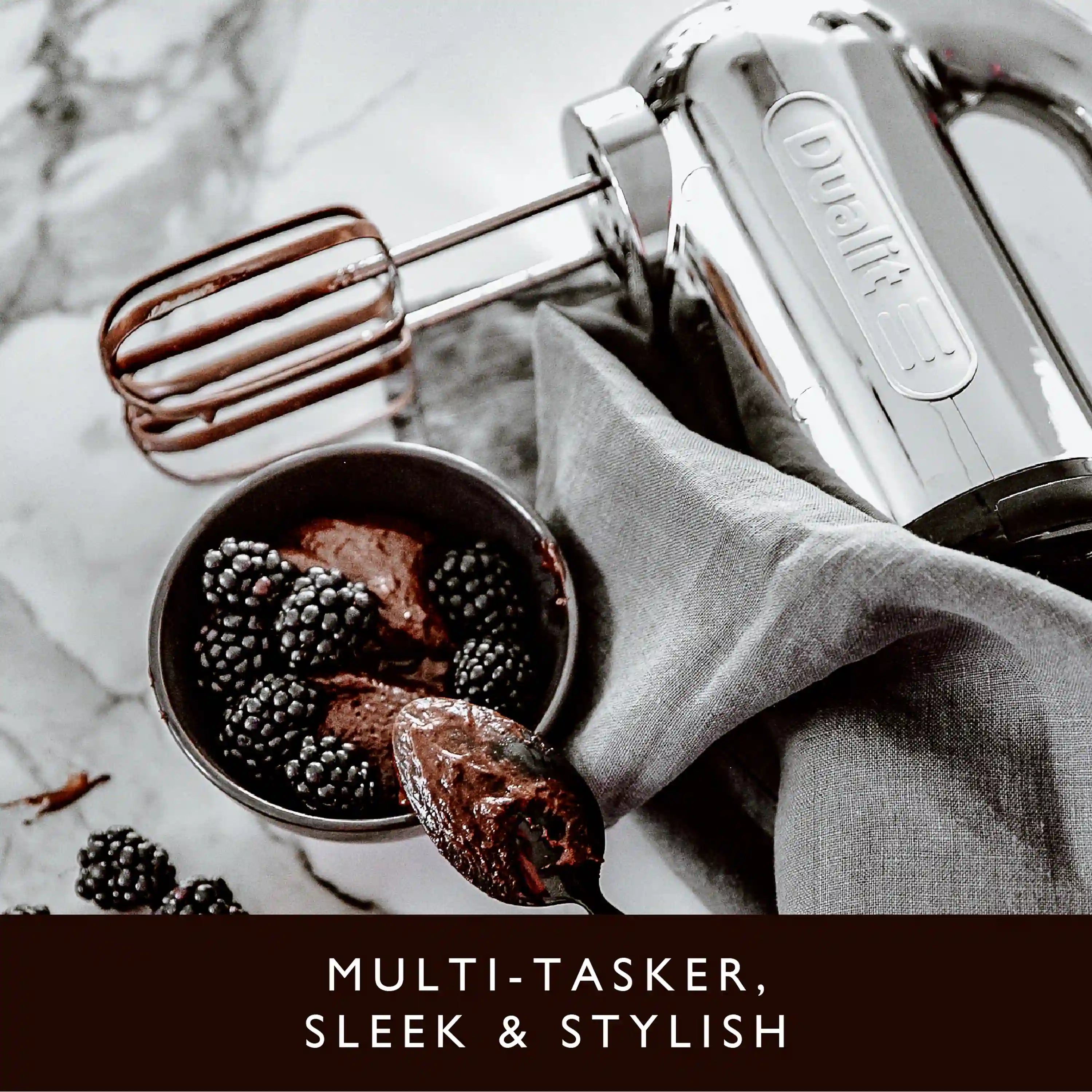 Polished chrome hand mixer whisking ingredients with beaters