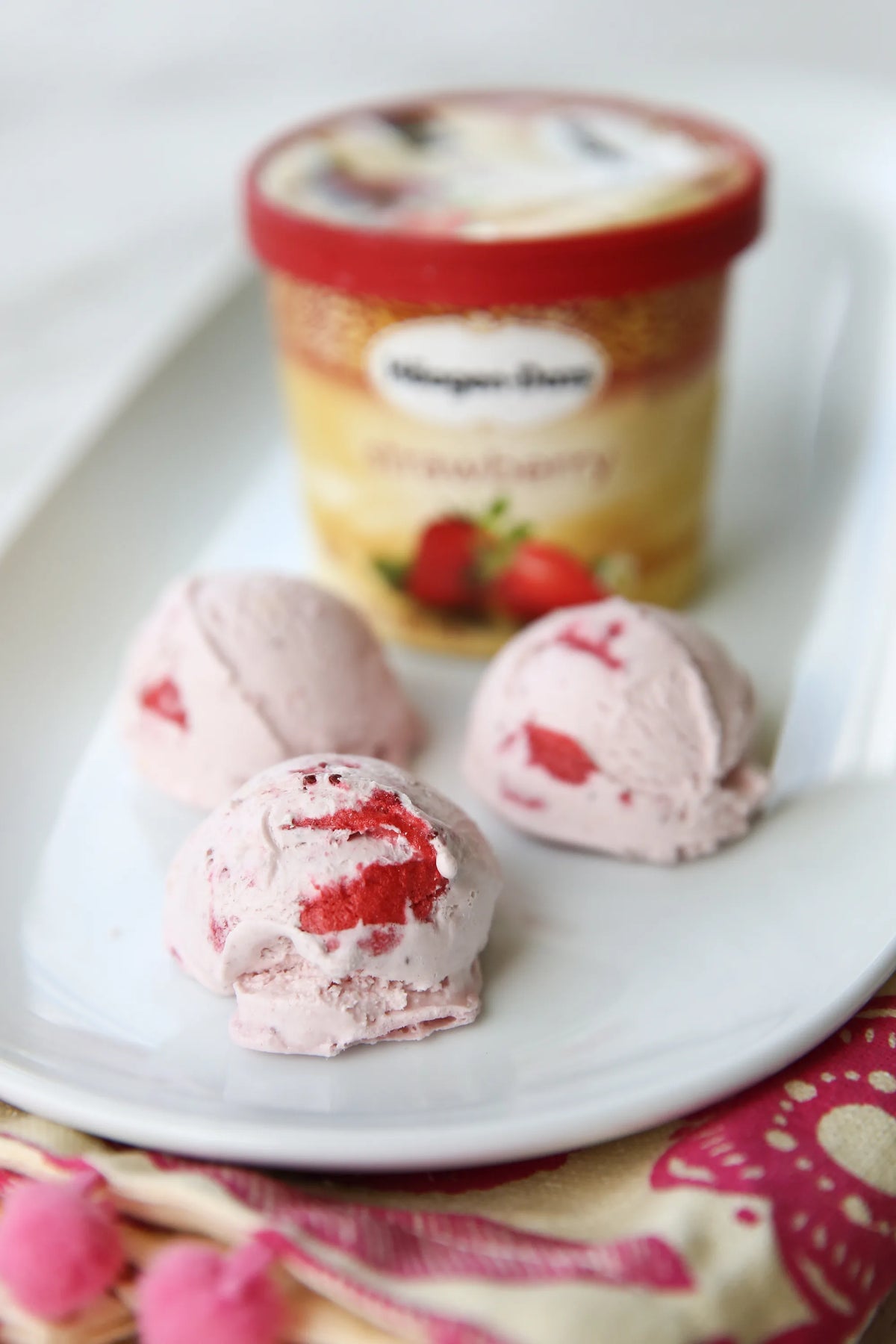 Freeze-dried dessert pieces on a plate with a sealed plastic jar container behind