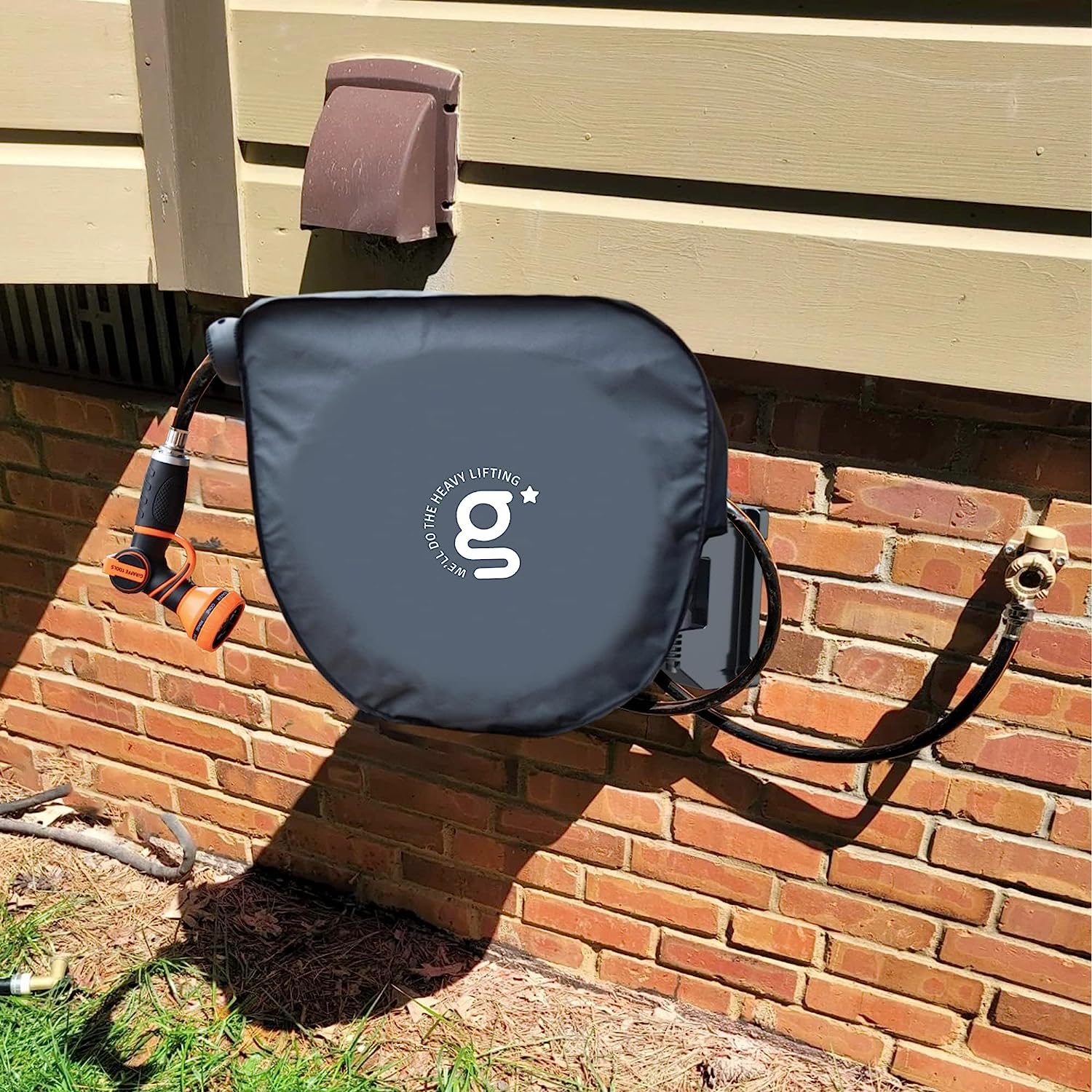 Dark gray hose reel cover mounted on wall with side straps and zipper