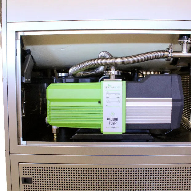 Commercial freeze dryer vacuum pump and hoses inside cabinet, access panel open