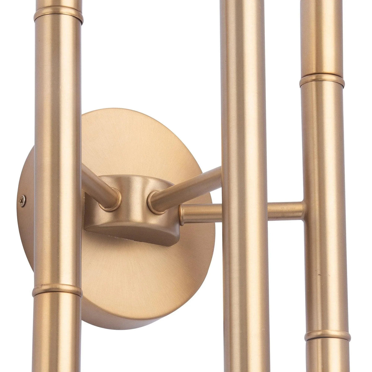 Close-up of golden round wall plate and side bracket for a multi-light tube sconce