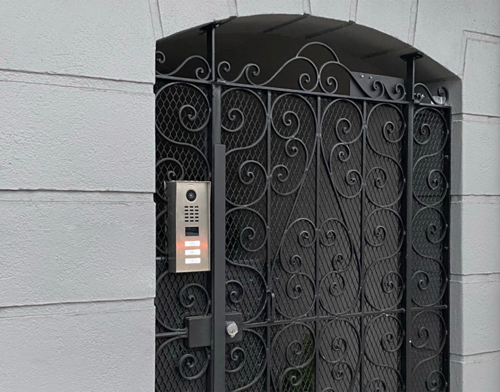 Black metal gate door intercom unit with camera and vertical call button panel