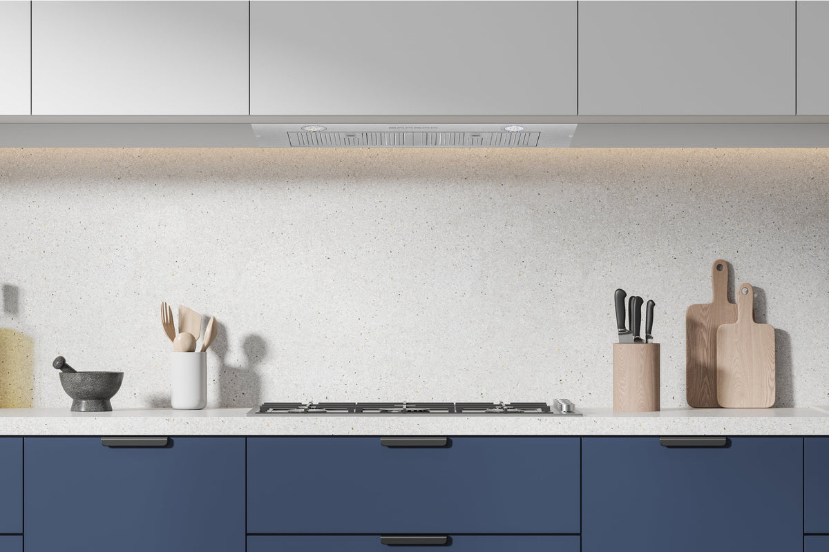 Recessed range hood insert above cooktop with metal vent opening