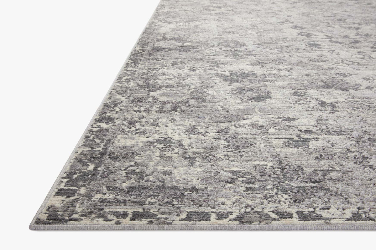 Charcoal and silver abstract distressed area rug with short pile and border