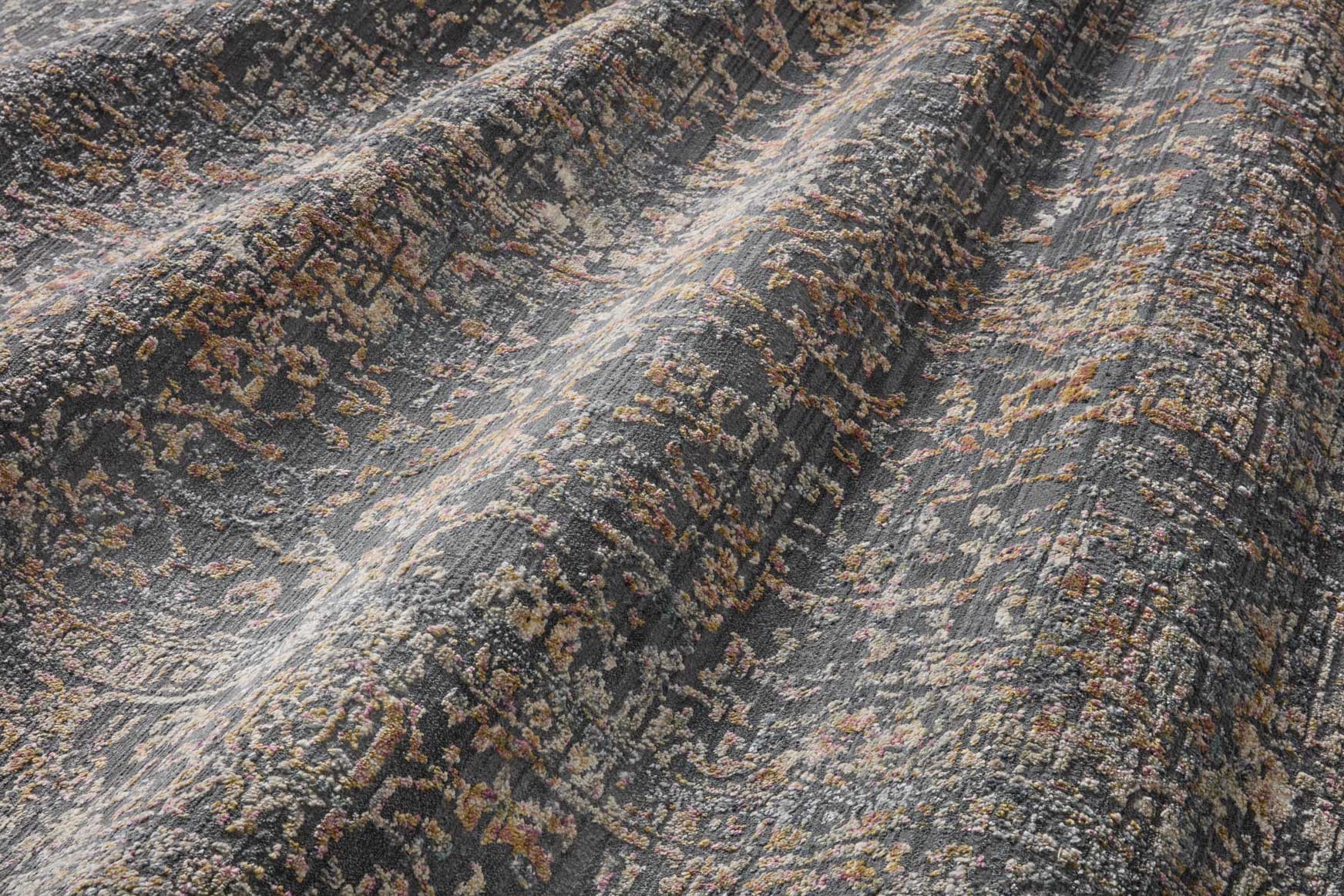 Textured area rug in graphite with muted gold and speckled abstract motif