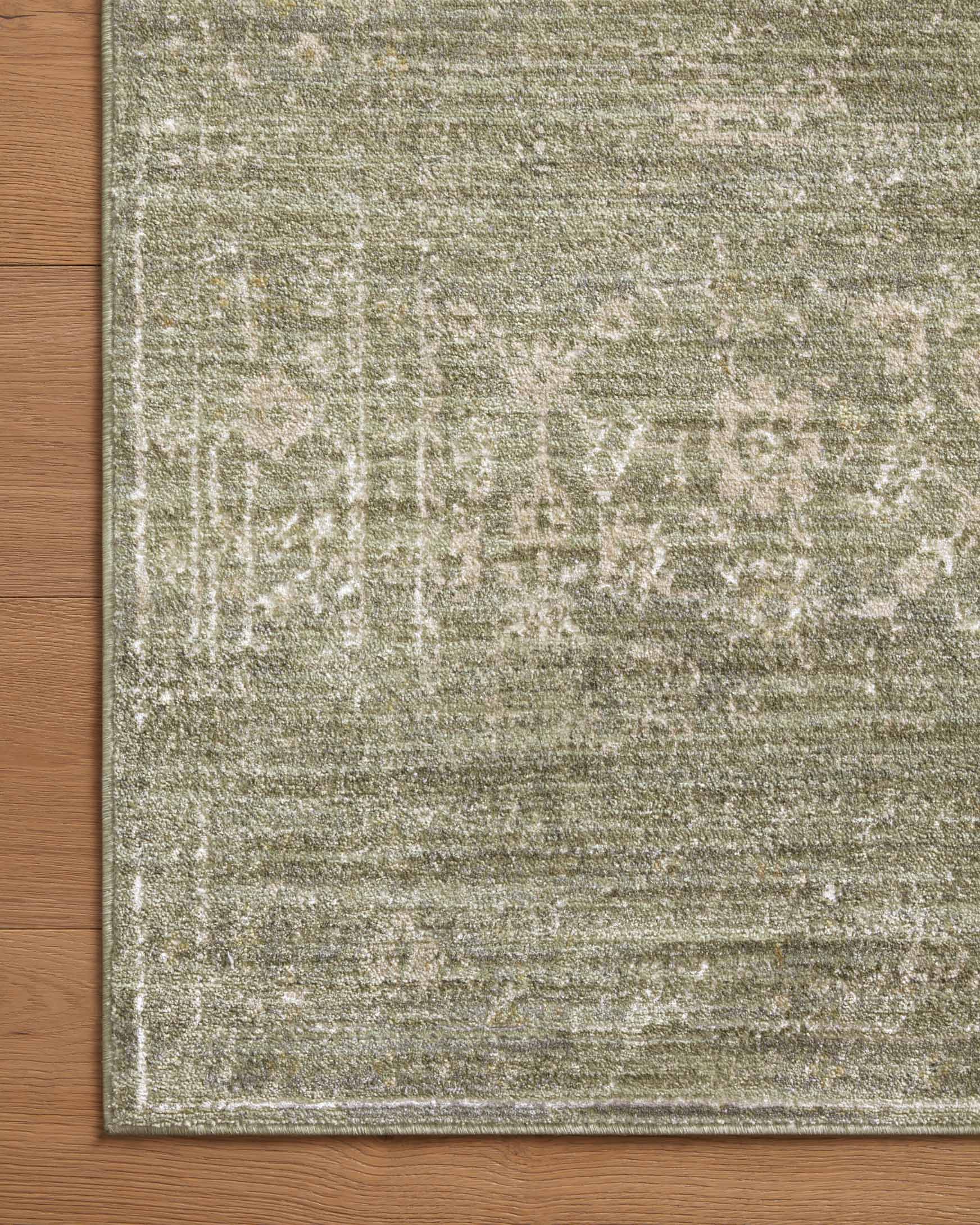 Sage and natural textured runner rug with abstract lines near a wood floor edge