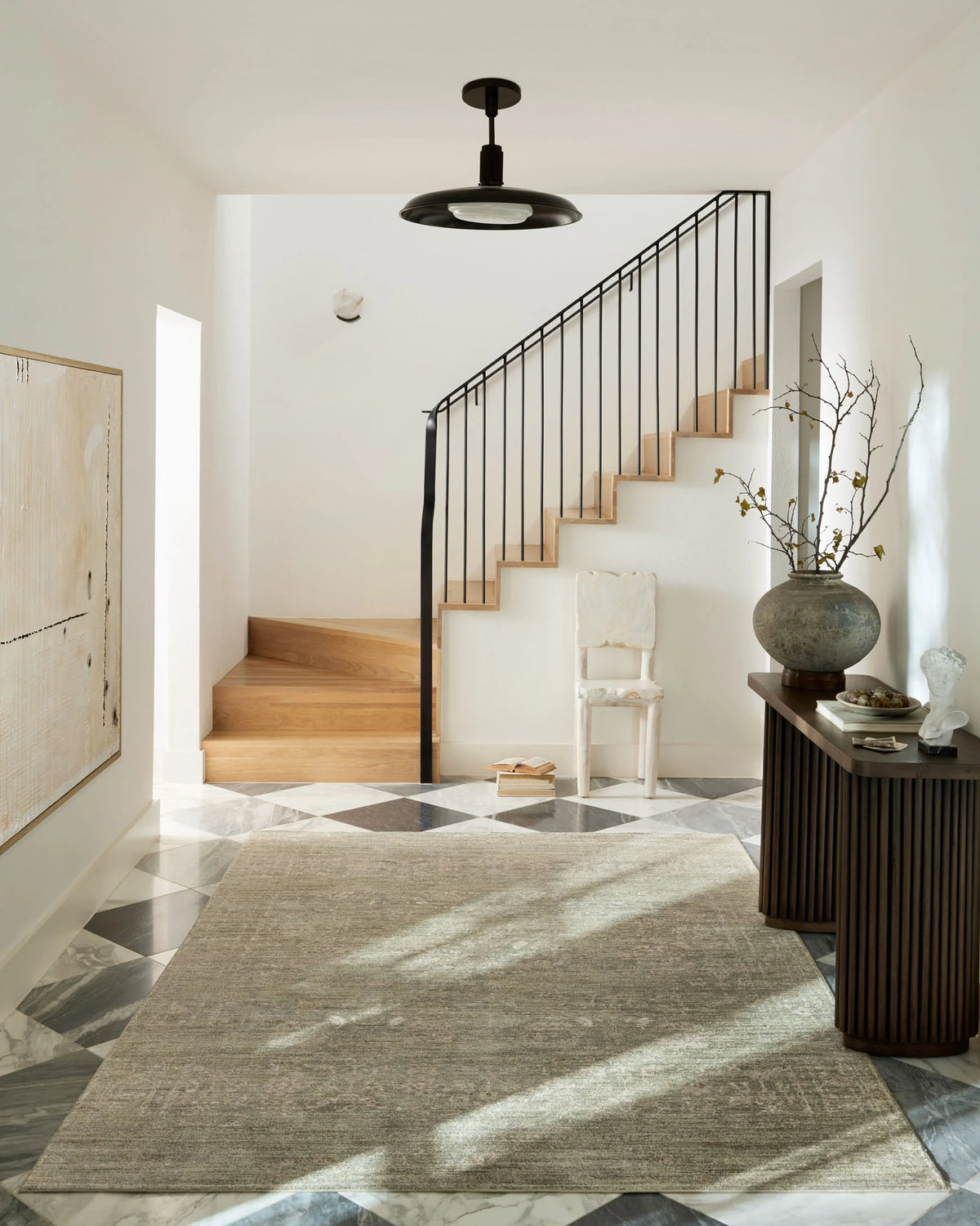 Loloi Indra sage and natural area rug on floor, mottled textured abstract pattern