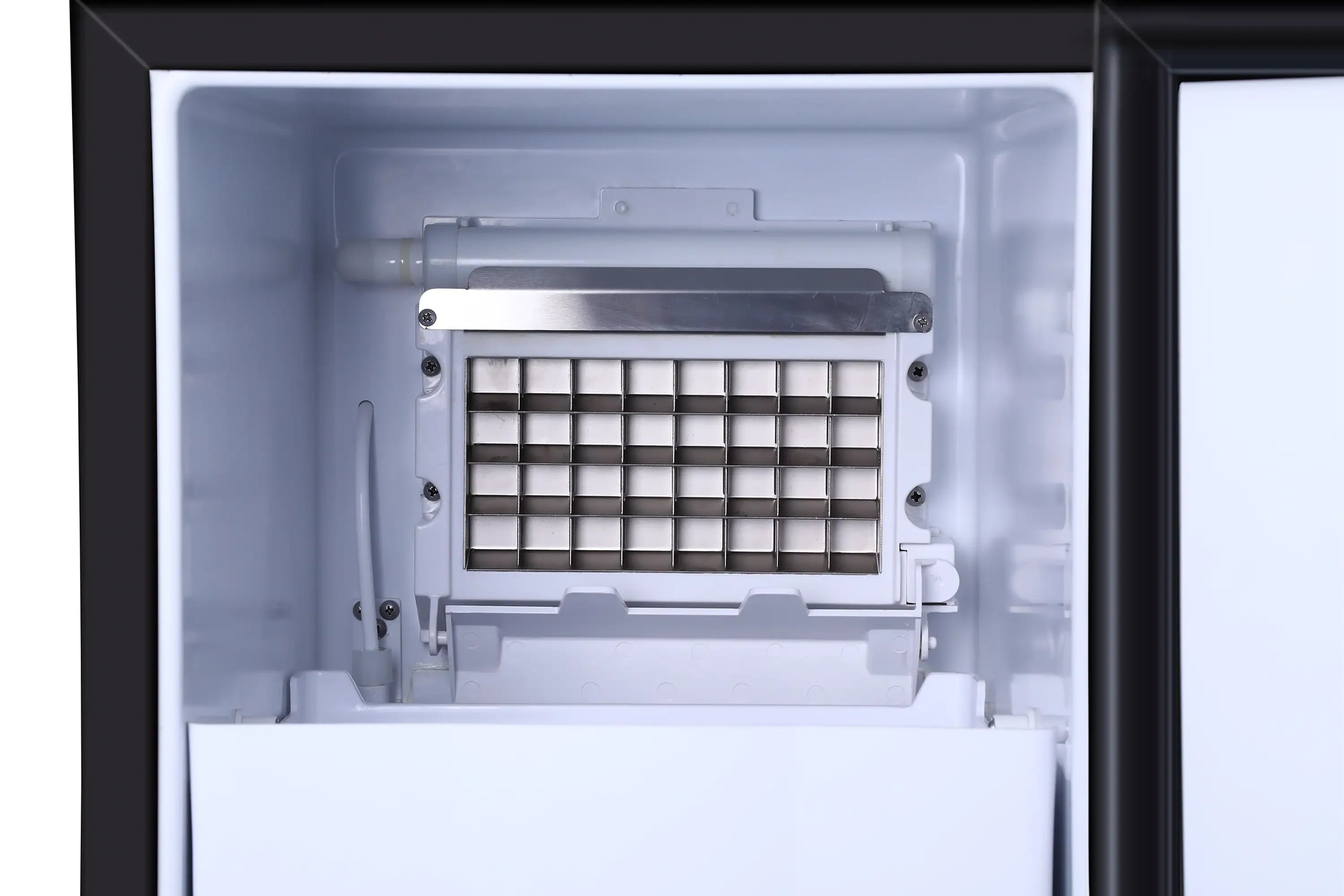 Built-in stainless ice maker with open door and ice tray grid inside