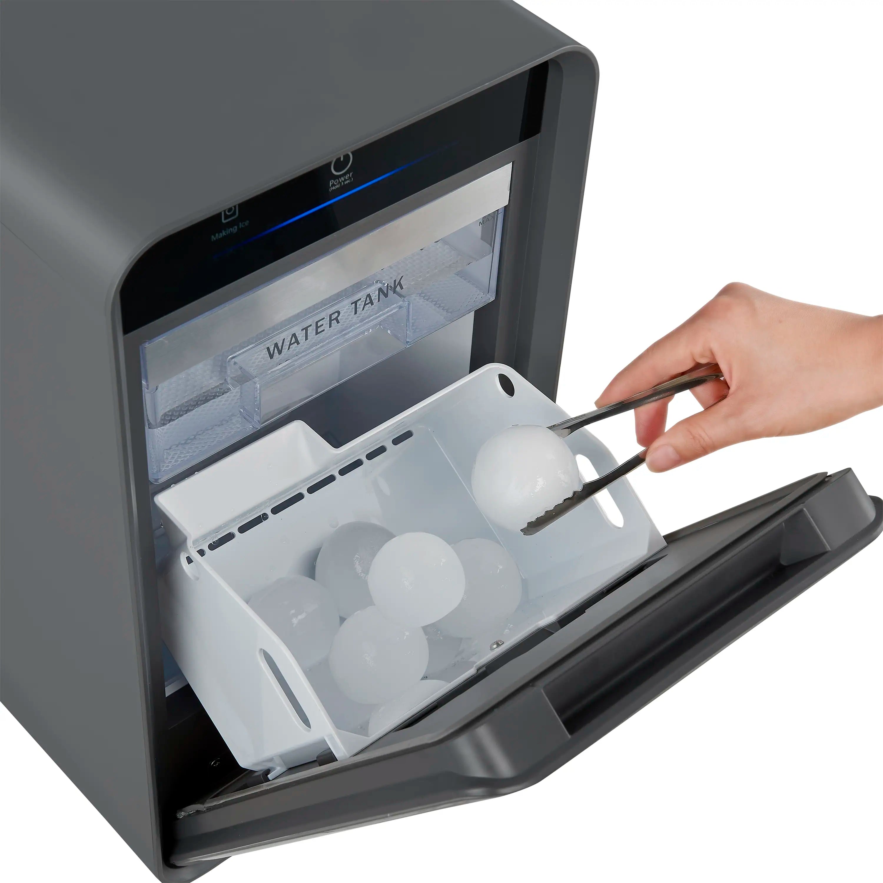 Ice maker front open with clear chamber and spherical ice molds inside