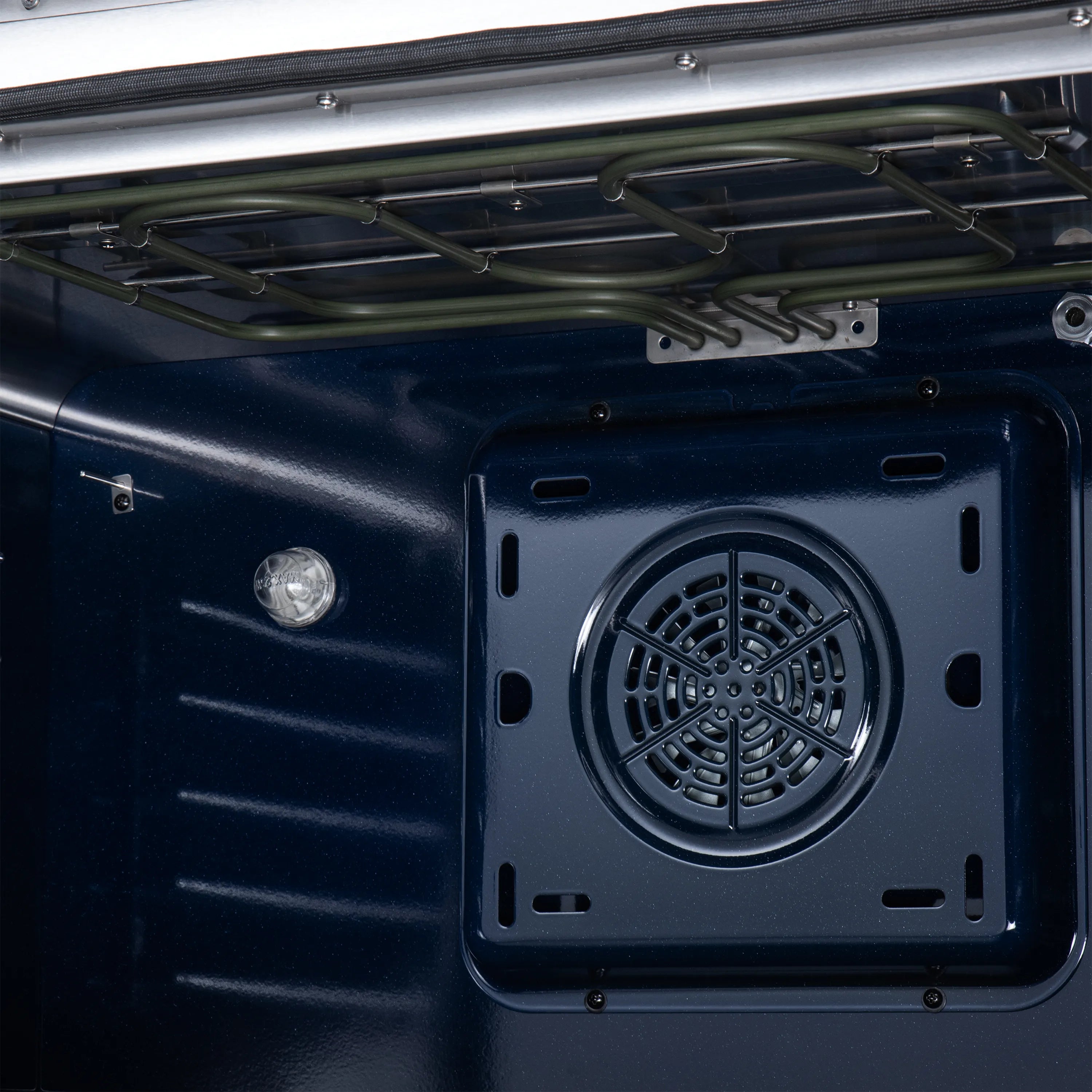 Black oven cavity rear fan/vent cover with circular airflow opening