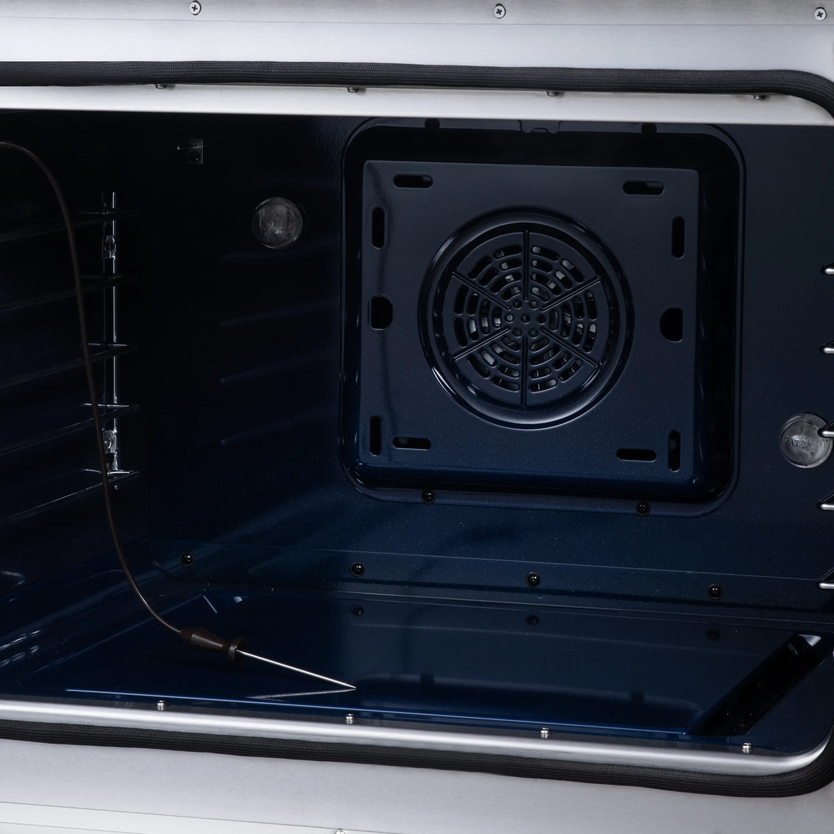 Black oven cavity front view with circular fan vent opening and heating parts