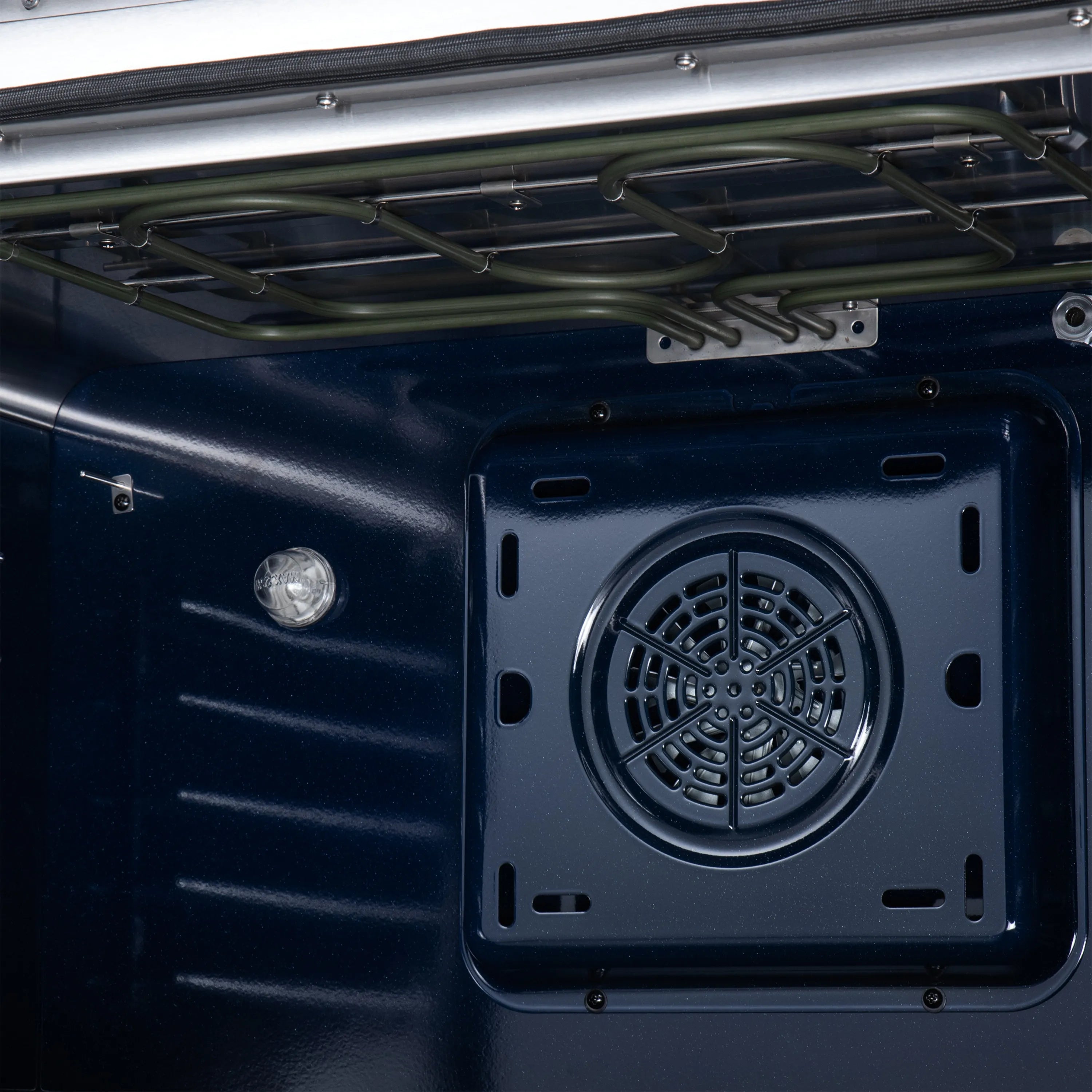 Convection fan vent opening on the back wall of the oven cavity