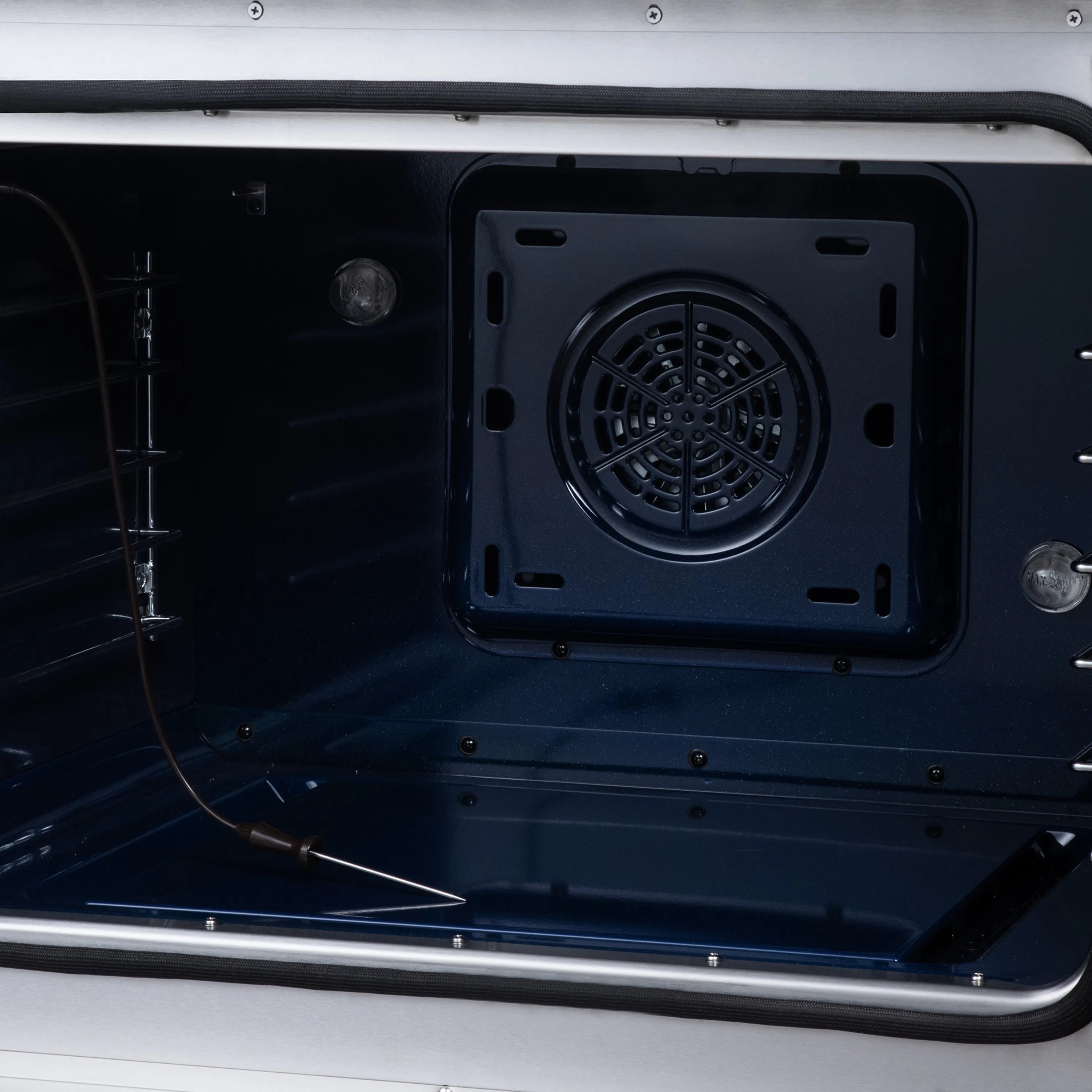 Blue enamel oven cavity with convection fan vent opening in the back
