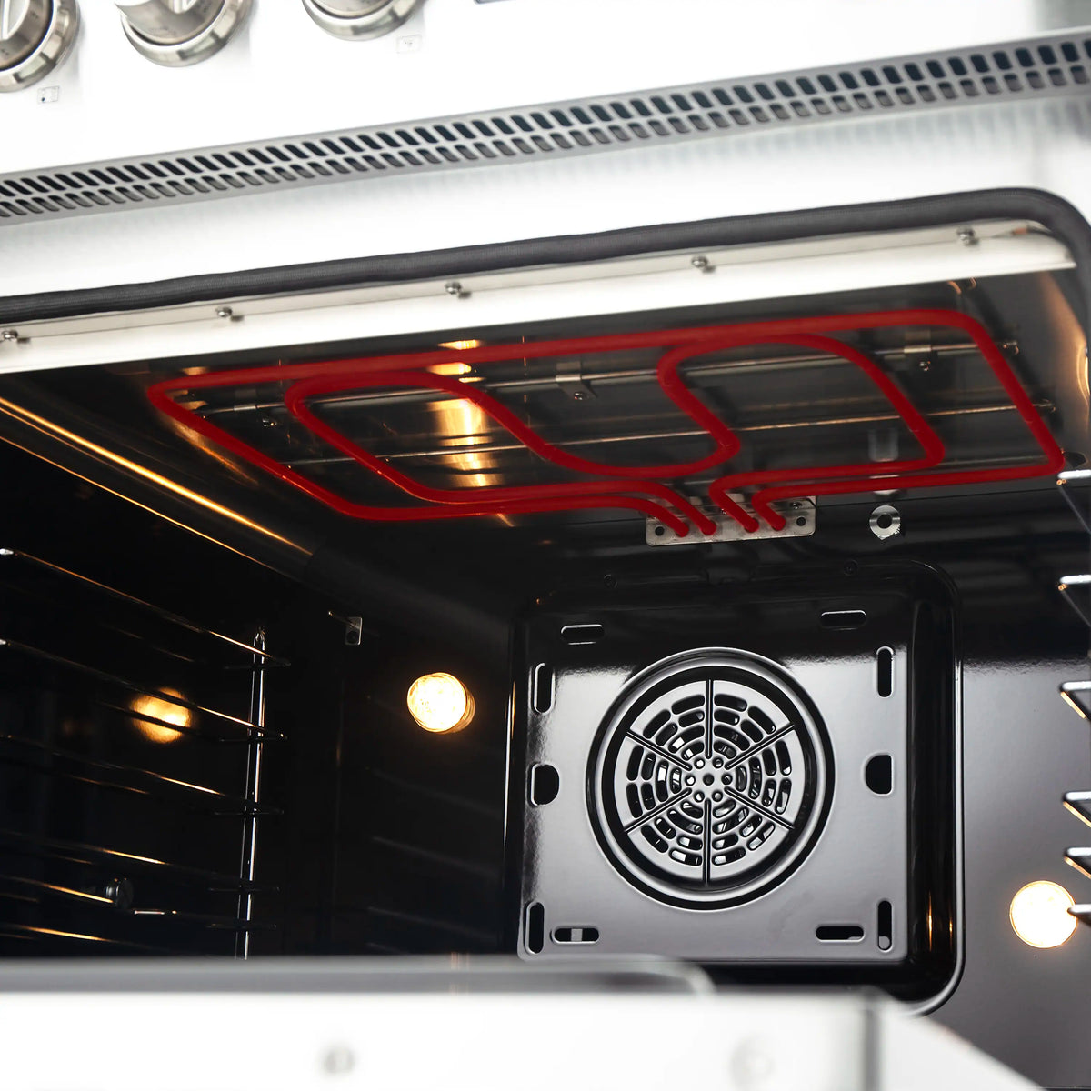 Convection oven interior with fan and red heating element