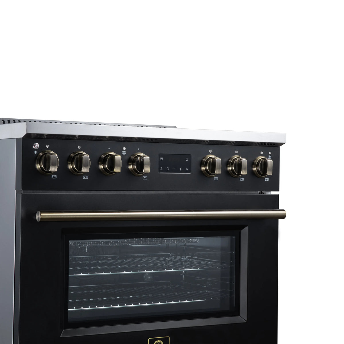 Black induction range control panel with brass-trim knobs and oven window