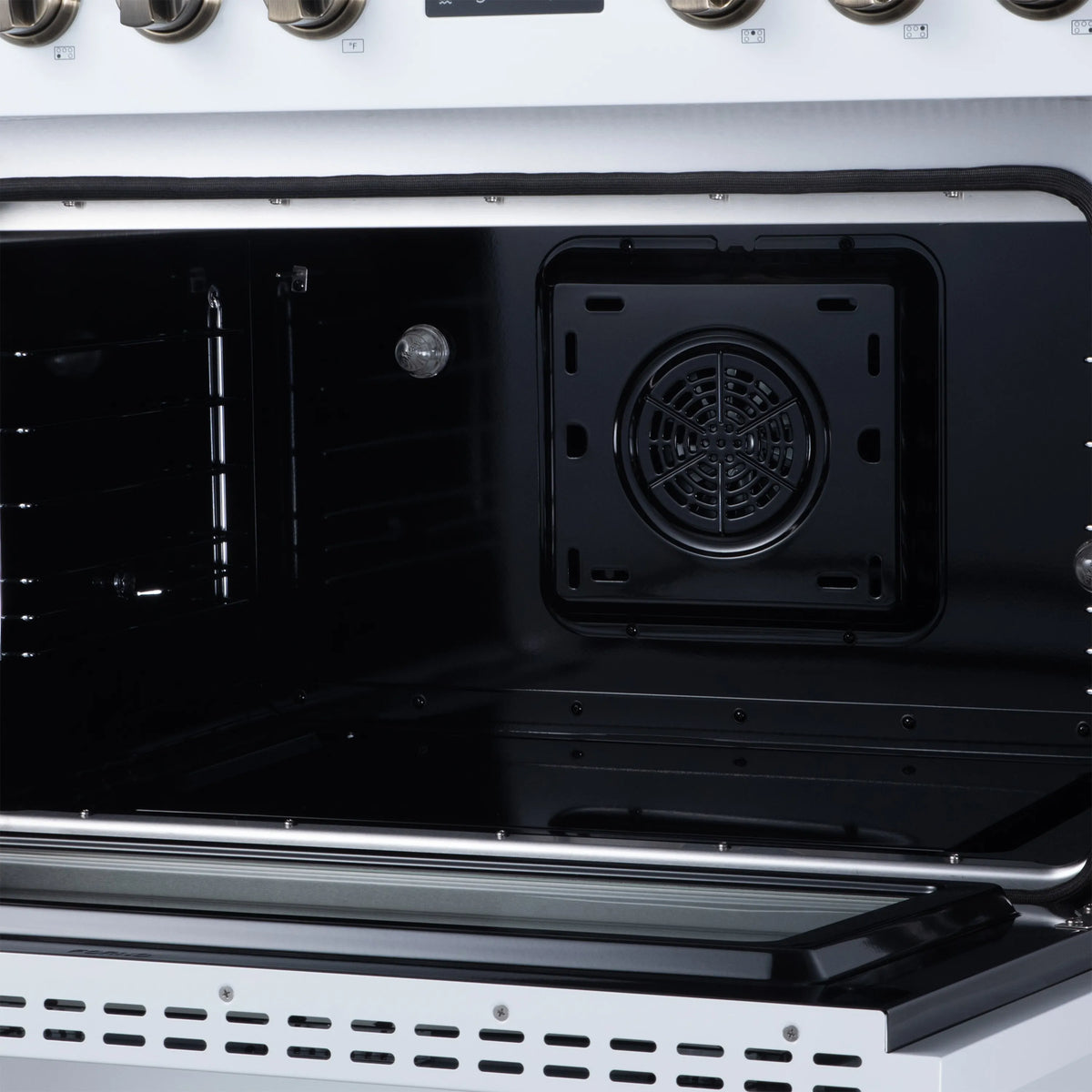 White oven interior with rear fan vent and black enamel walls, door open.