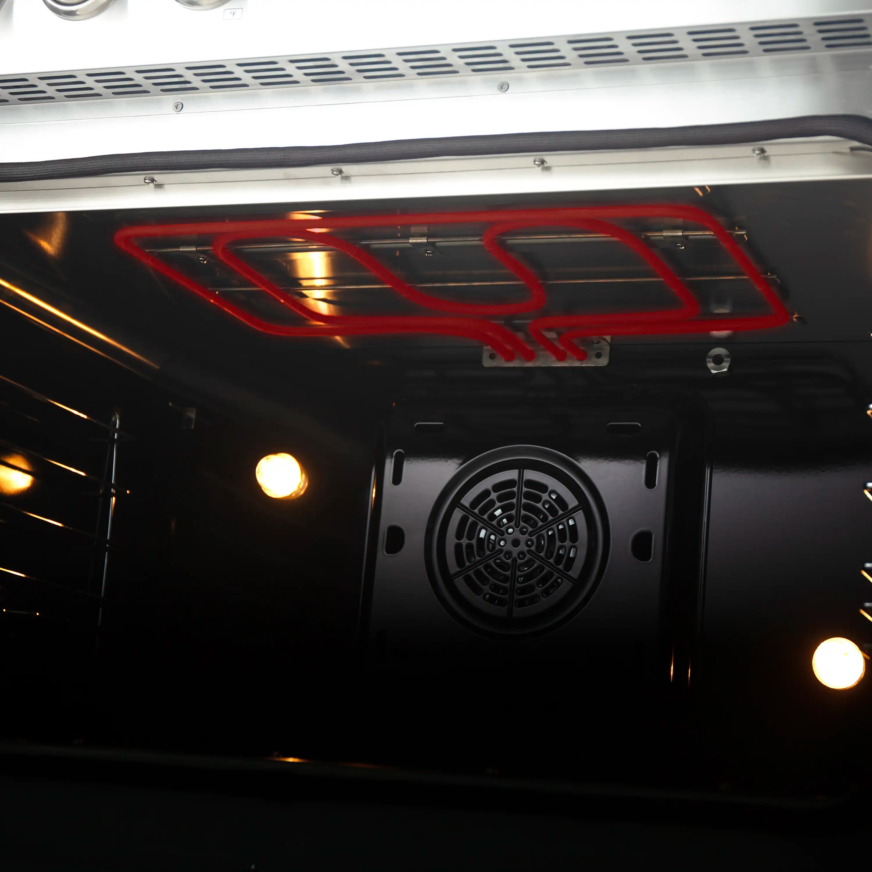 Close-up of induction oven interior with fan vent and red heating element