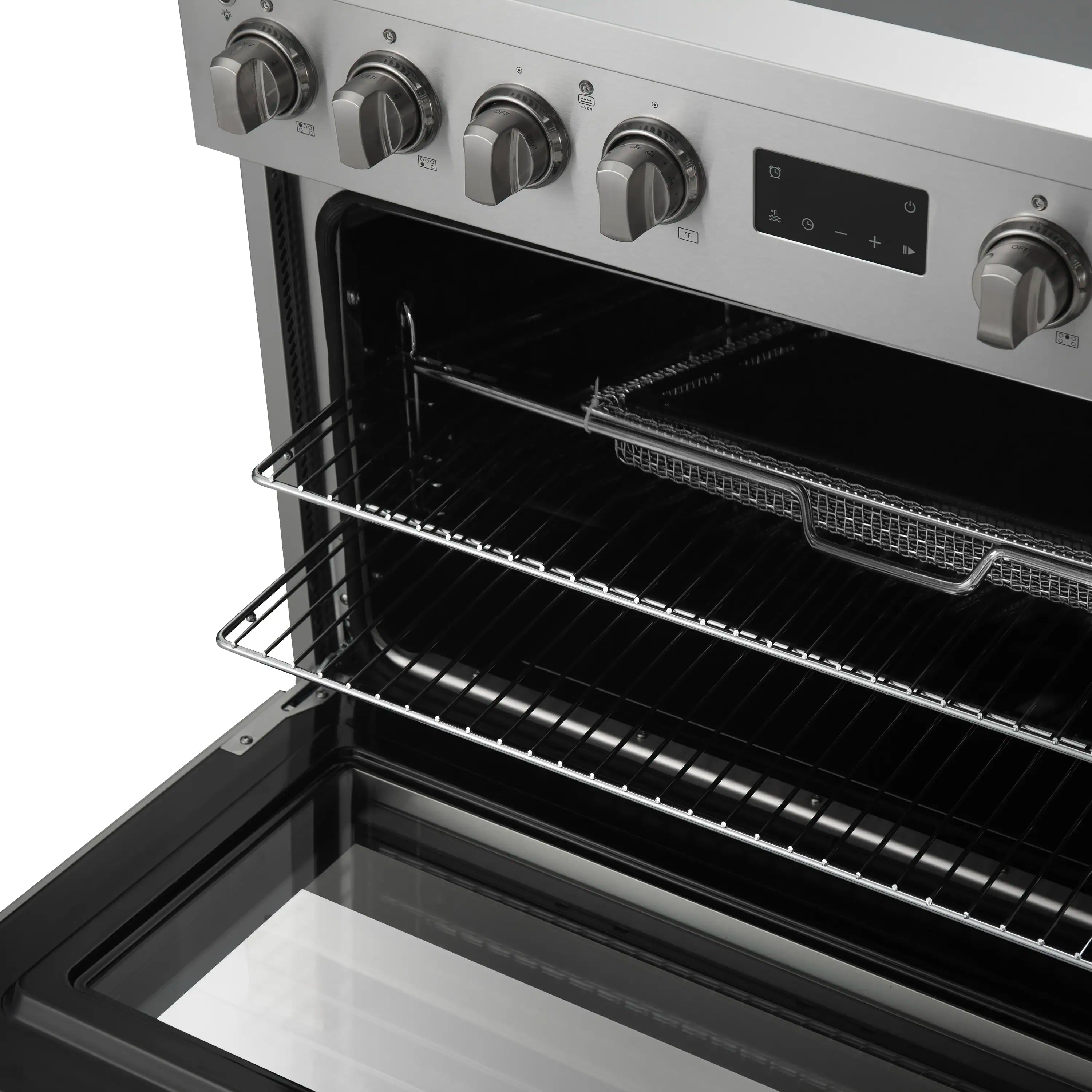 Oven interior of a stainless steel induction range with wire rack and broiler element