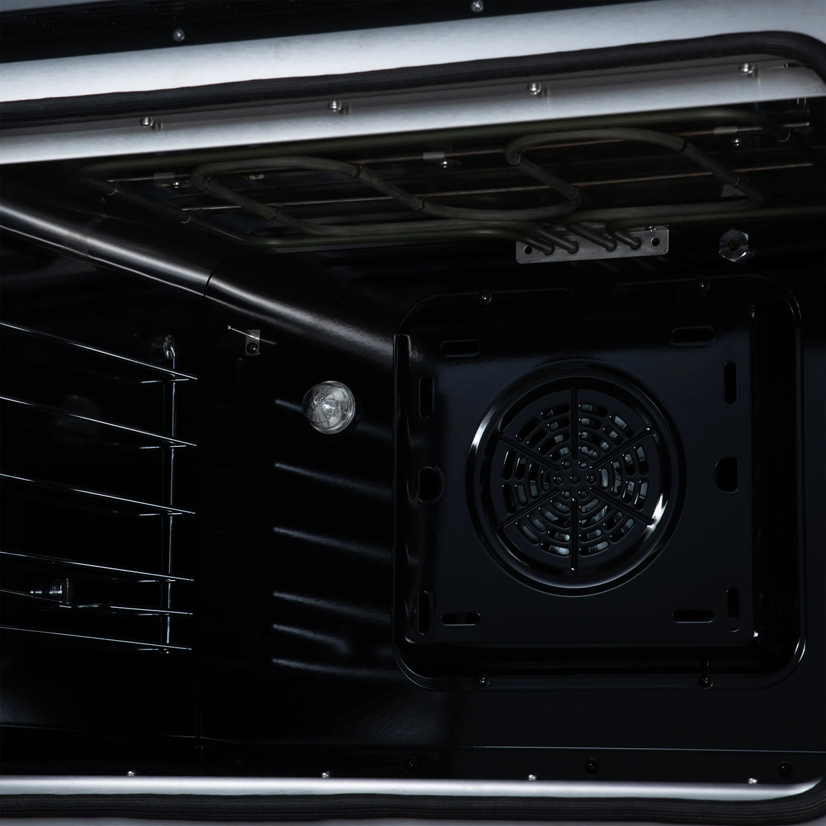 Black oven interior with convection fan grille and upper heating element detail
