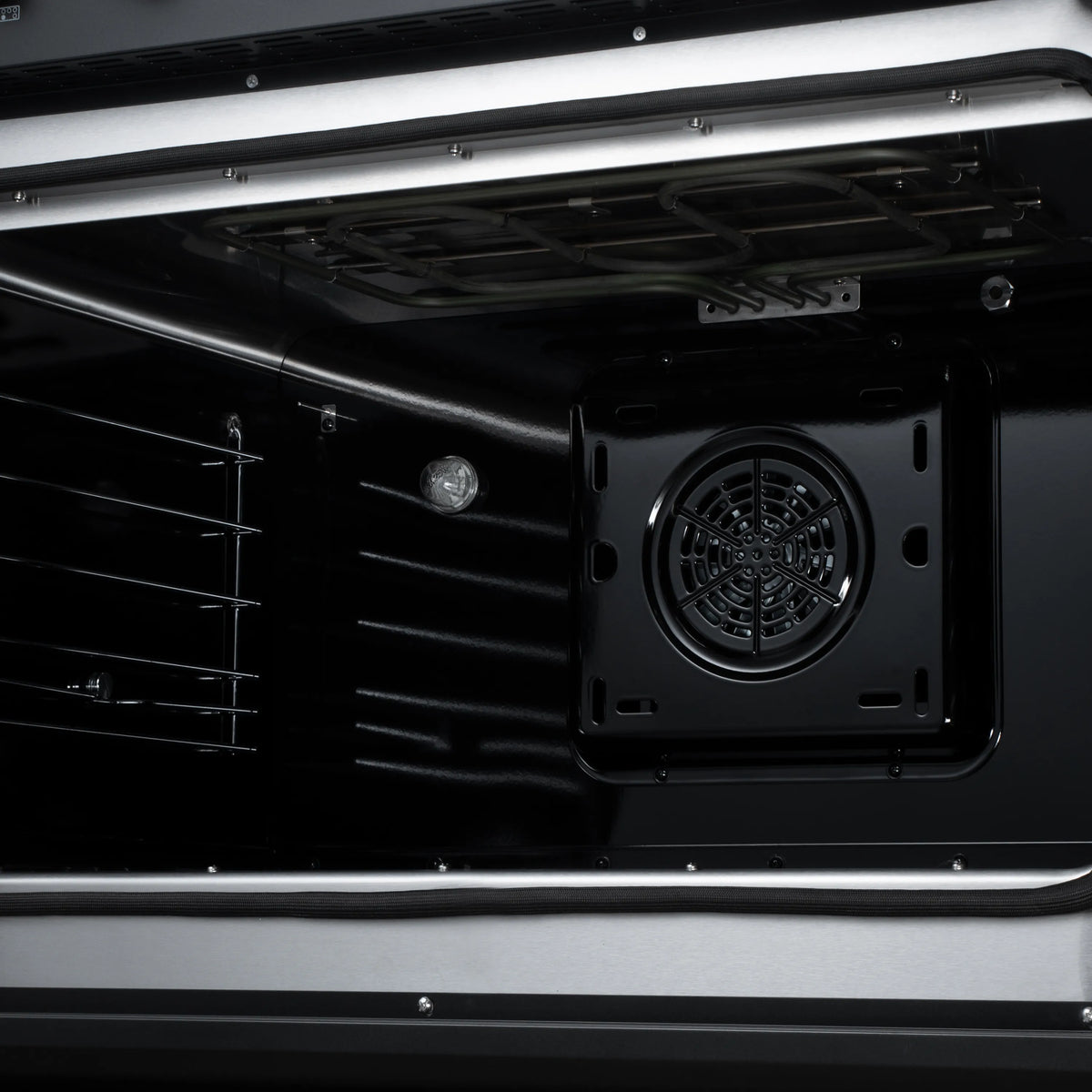Induction range oven interior with rear convection fan and vent opening