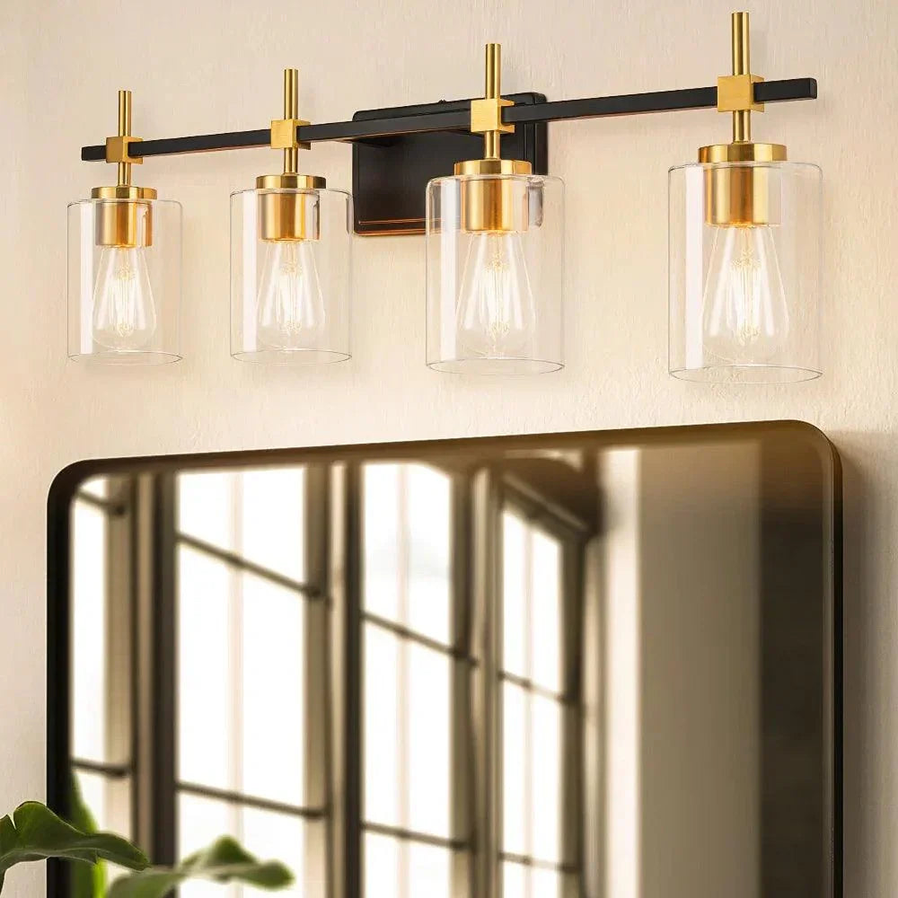 Four-light vanity light: black metal frame with clear glass cylinders and gold mounts