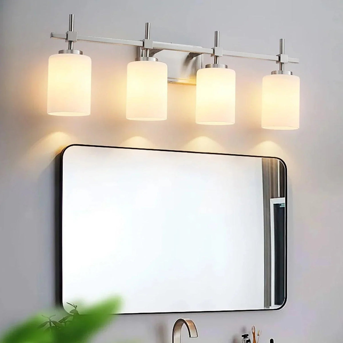 Brush nickel four-light bathroom vanity light with frosted glass shades